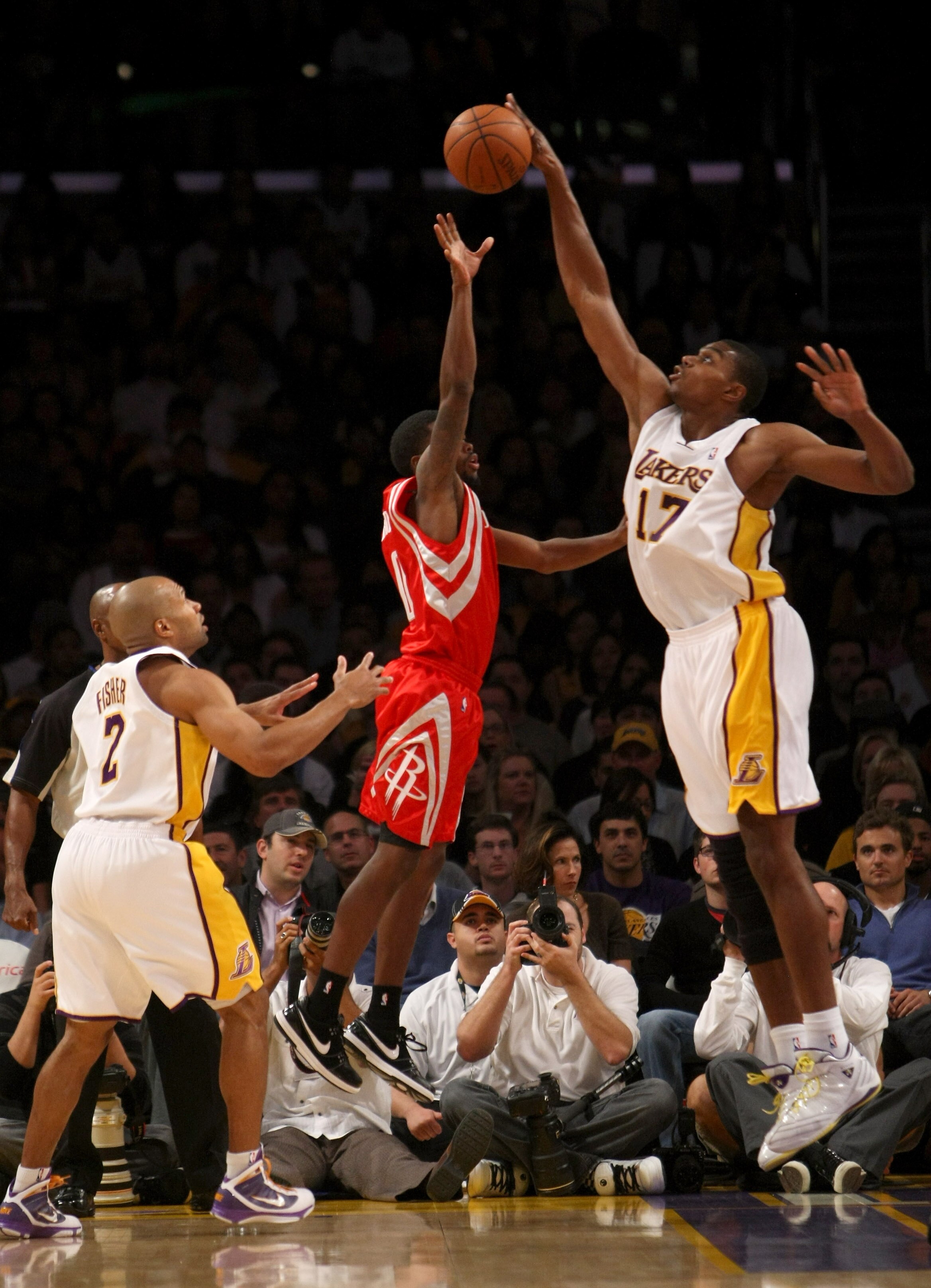 LOS ANGELES - NOVEMBER 15:  Andrew Bynum #17 of the Los Angeles Lakers blocks a shot by Aaron Brooks #1 of the Houston Rockets as Laker Derek Fisher #3 looks on in the game on November 15, 2009 at Staples Center in Los Angeles, California.  The Rockets wo