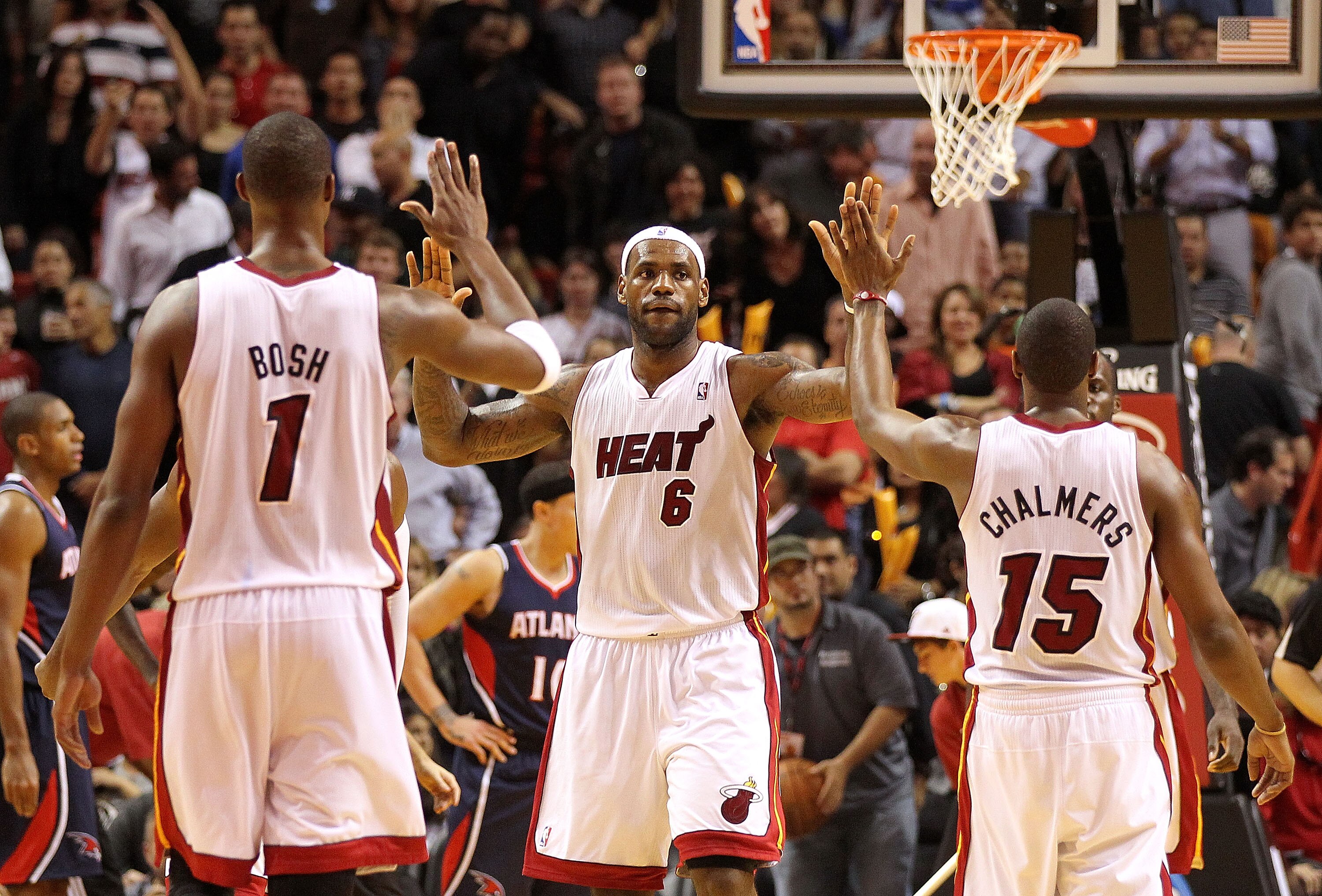 MIAMI, FL - DECEMBER 04:  LeBron James #6 of the Miami Heat is congratulated by Chris Bosh #1 and Mario Chalmers #15 during a game against the Atlanta Hawks at American Airlines Arena on December 4, 2010 in Miami, Florida. NOTE TO USER: User expressly ack