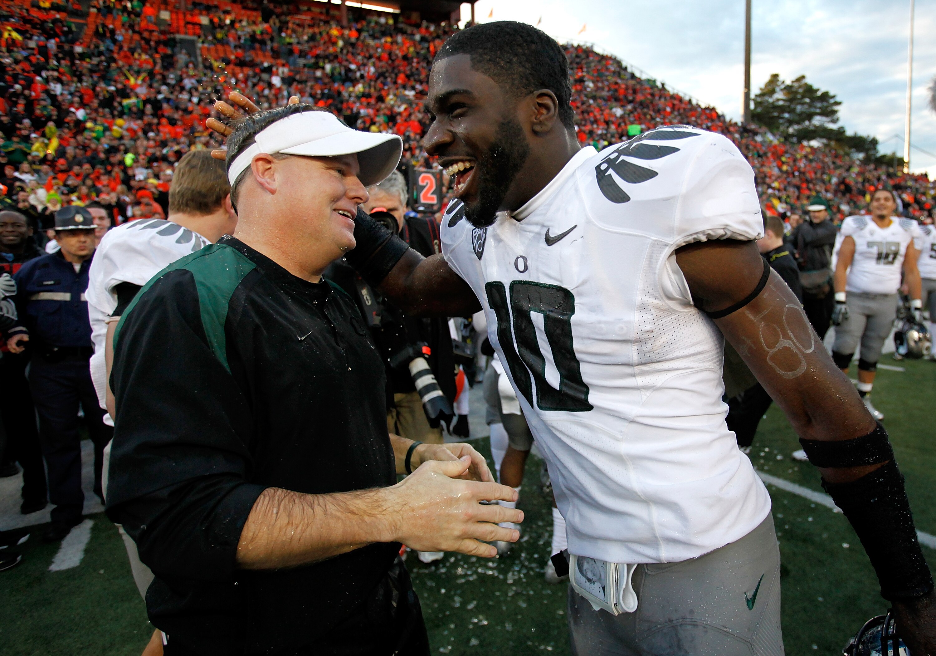 CORVALLIS, OR - DECEMBER 04:  Head Coach Chip Kelly of the Oregon Ducks laughs with Drew Davis #10 after having Gatorade dumped on him after the 37-20 victory over the Oregon State Beavers during the 114th Civil War on December 4, 2010 at the Reser Stadiu
