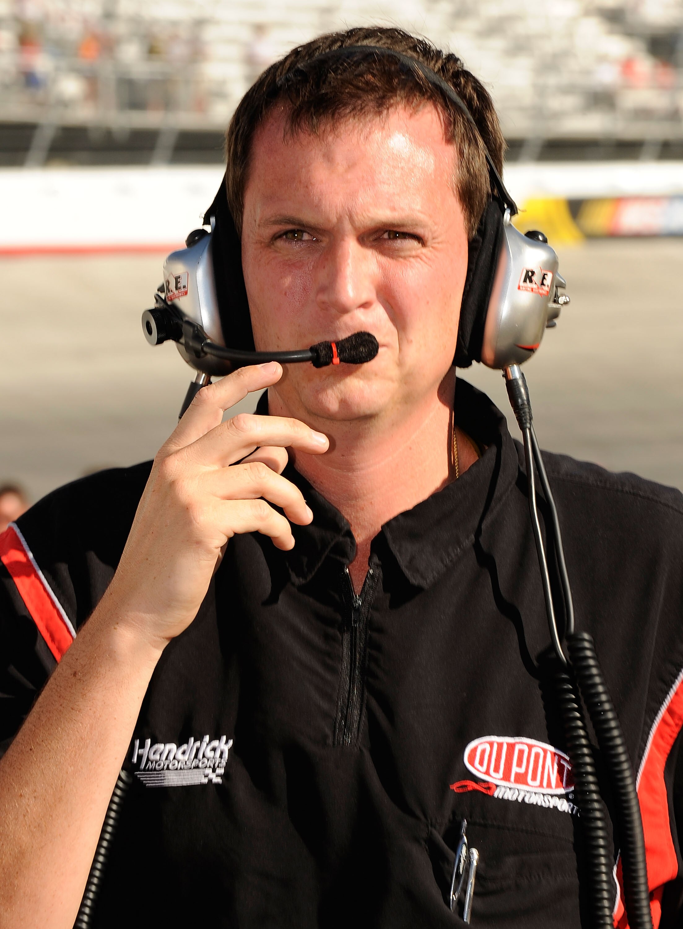 BRISTOL, TN - AUGUST 20:  Steve Letarte, crew chief of the #24 DuPont Chevrolet, driven by Jeff Gordon, walks on the grid to talk to NASCAR Officials after Gordon hit the wall around turn four before taking the green flag to qualify for the NASCAR Sprint