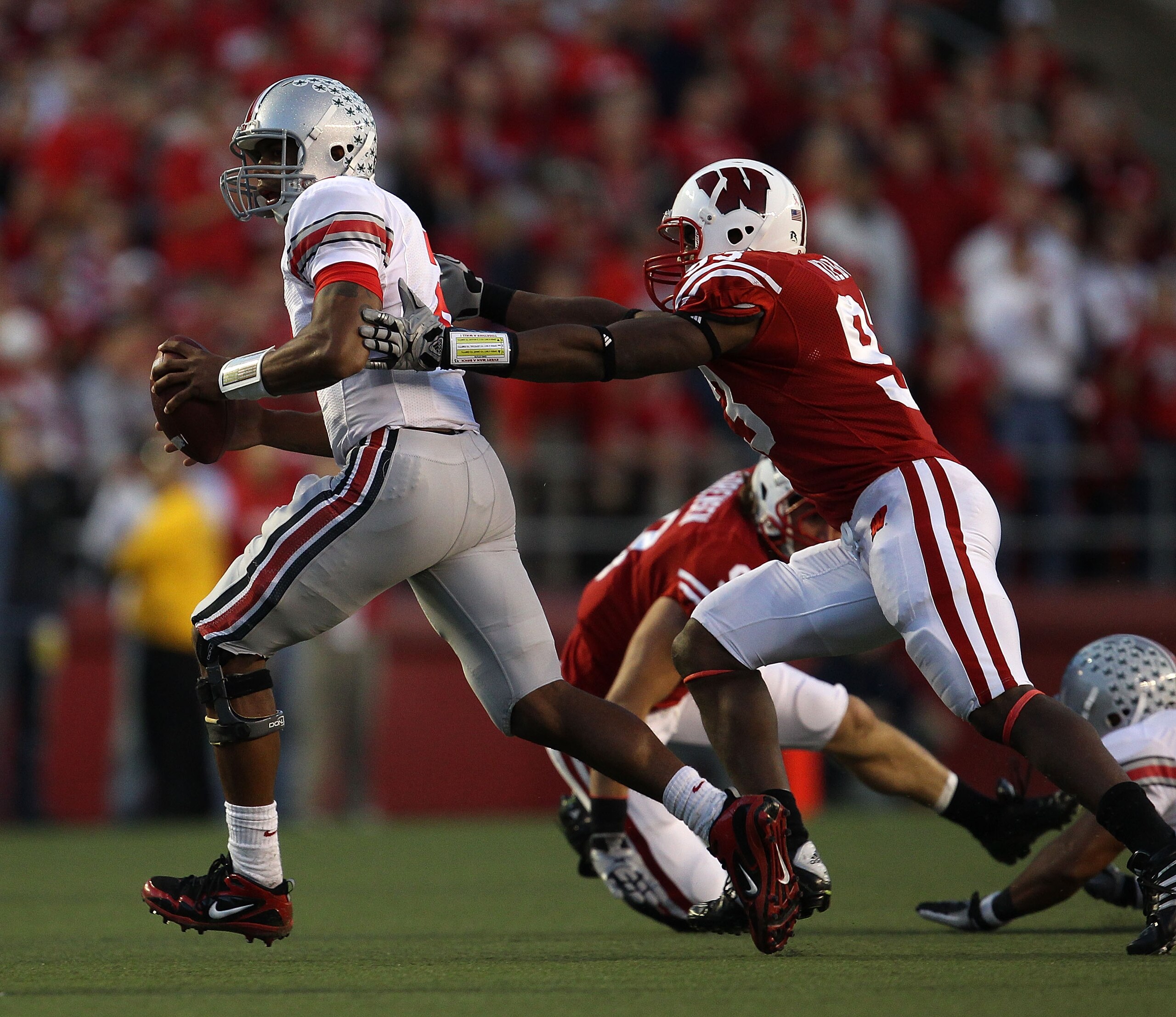 MADISON, WI - OCTOBER 16: Terrelle Pryor #2 of the Ohio State Buckeyes is chased by Louis Nzegwu #93 of the Wisconsin Badgers at Camp Randall Stadium on October 16, 2010 in Madison, Wisconsin. Wisconsin defeated Ohio State 31-18. (Photo by Jonathan Daniel MADISON, WI - OCTOBER 16: Terrelle Pryor #2 of the Ohio State Buckeyes is chased by Louis Nzegwu #93 of the Wisconsin Badgers at Camp Randall Stadium on October 16, 2010 in Madison, Wisconsin. Wisconsin defeated Ohio State 31-18. (Photo by Jonathan Daniel