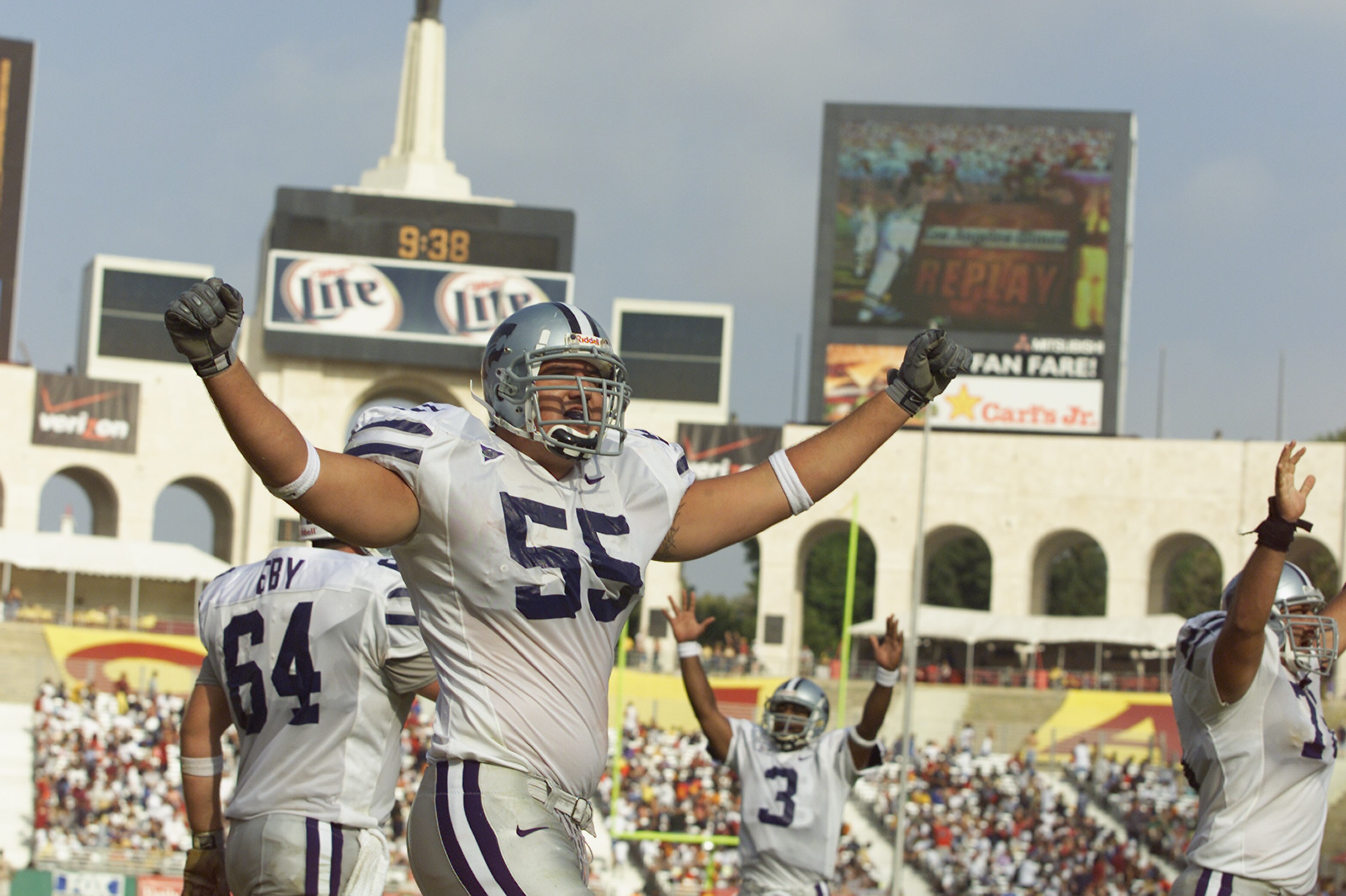 LOS ANGELES - SEPTEMBER 8:  Offensive Lineman Billy Miller #55 of the Kansas State Wildcats and his teammates wave their arms in the air to ask the fans to make noise against the University of Southern California Trojans during the game at the Los Angeles