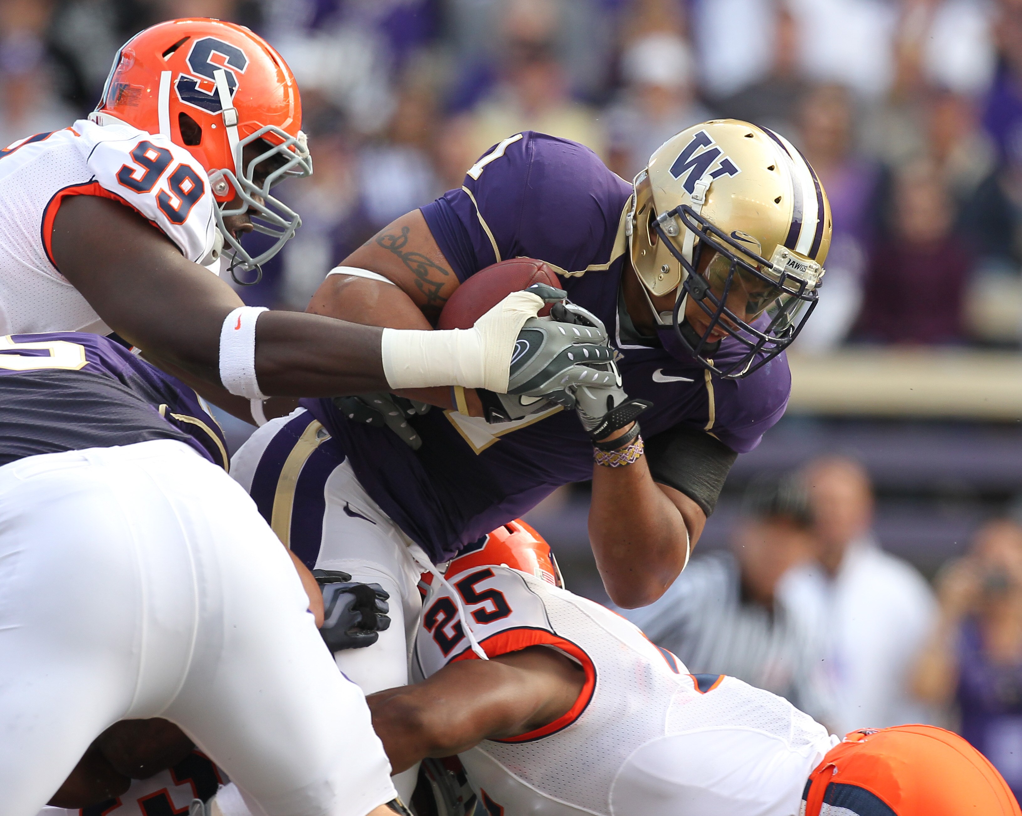 SEATTLE - SEPTEMBER 11:  Running back Chris Polk #1 of the Washington Huskies rushes against Derrell Smith #25 of the Syracuse Orange on September 11, 2010 at Husky Stadium in Seattle, Washington. (Photo by Otto Greule Jr/Getty Images)