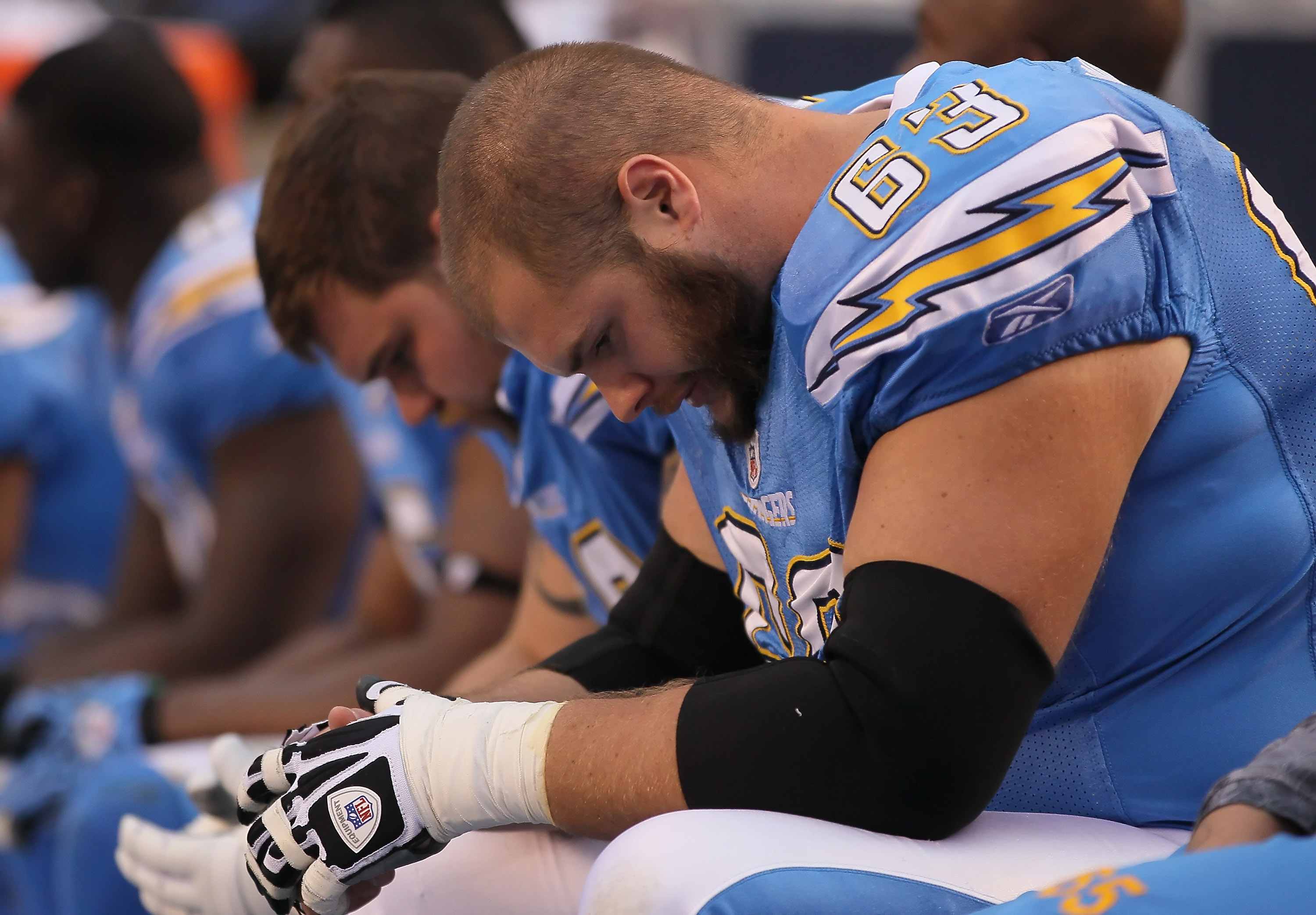 SAN DIEGO - DECEMBER 05:  Scott Mruczkowski #63 of the San Diego Chargers is seen dejected on the bench in the closing minutes of the fourth quarter against the Oakland Raiders at Qualcomm Stadium on December 5, 2010 in San Diego, California. The Raiders