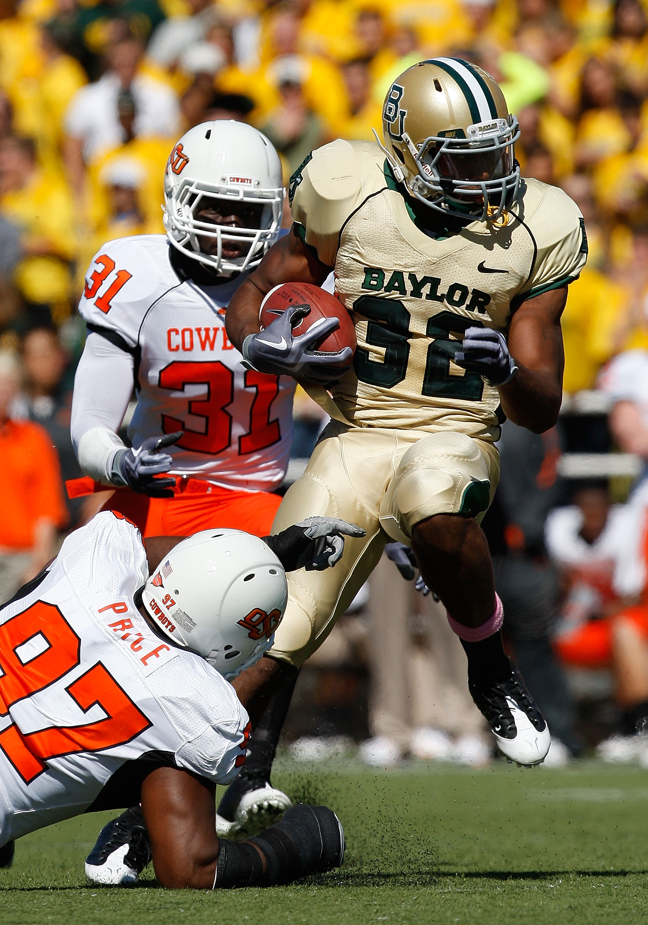 WACO, TX - OCTOBER 24:  Running back Jay Finley #32 of the Baylor Bears runs the ball past Jeremiah Price #97 of the Oklahoma State Cowboys at Floyd Casey Stadium on October 24, 2009 in Waco, Texas.  (Photo by Ronald Martinez/Getty Images)