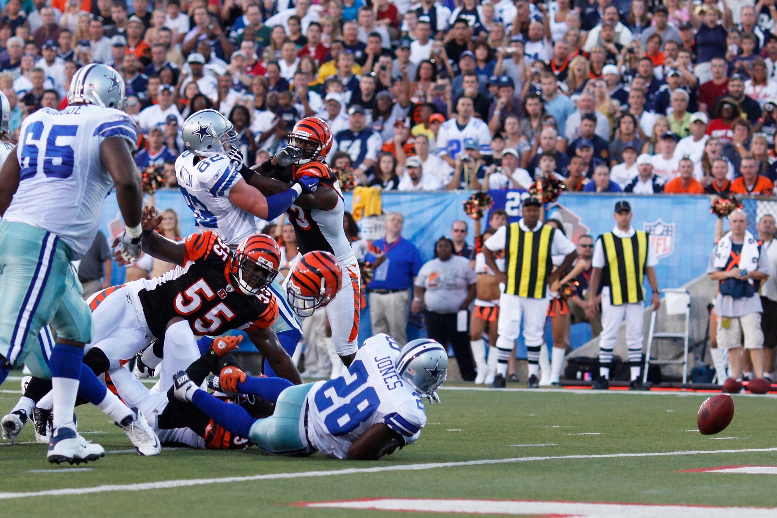 CANTON, OH - AUGUST 8: Felix Jones #28 of the Dallas Cowboys fumbles the football near the goal line after being his by Roy Williams #31 of the Cincinnati Bengals during the 2010 Pro Football Hall of Fame Game at the Pro Football Hall of Fame Field at Faw