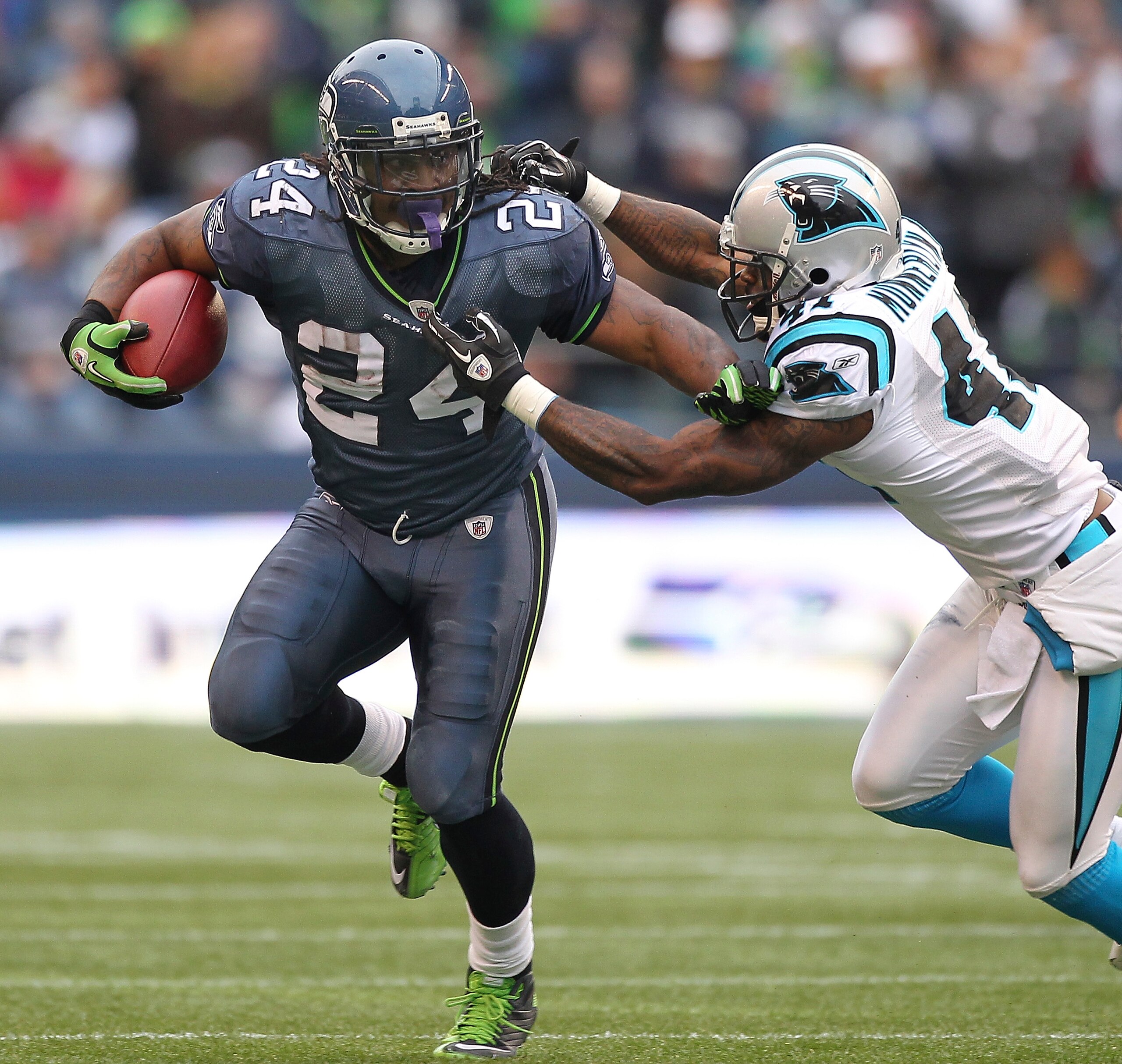 SEATTLE, WA - DECEMBER 05:  Running back Marshawn Lynch #24 of the Seattle Seahawks rushes against Captain Munnerlyn #41 of the Carolina Panthers at Qwest Field on December 5, 2010 in Seattle, Washington. The Seahawks defeated the Panthers 31-14. (Photo b