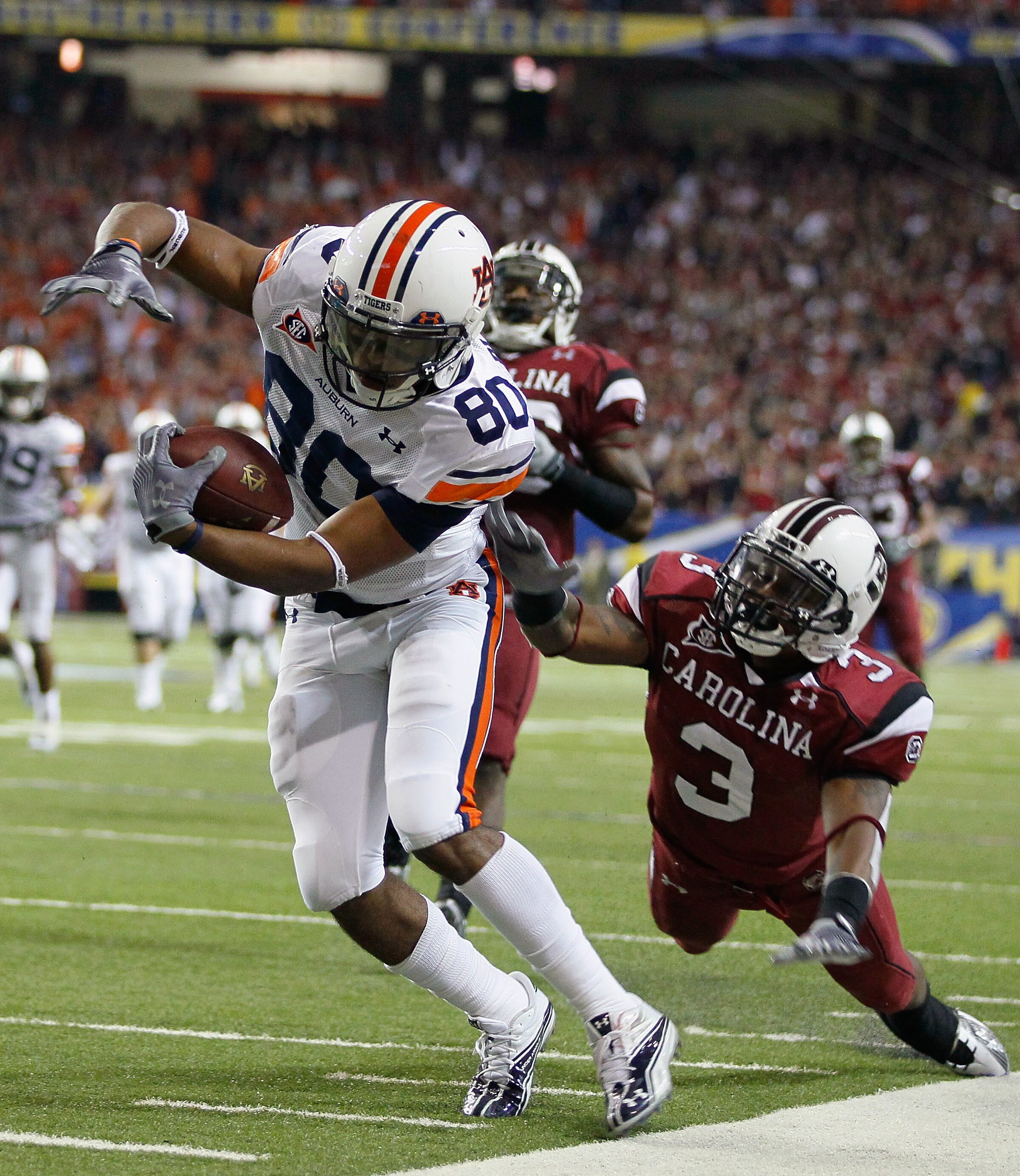 ATLANTA, GA - DECEMBER 04:  Emory Blake #80 of the Auburn Tigers is tackled by Akeem Auguste #3 of the South Carolina Gamecocks during the 2010 SEC Championship at Georgia Dome on December 4, 2010 in Atlanta, Georgia.  (Photo by Kevin C. Cox/Getty Images)