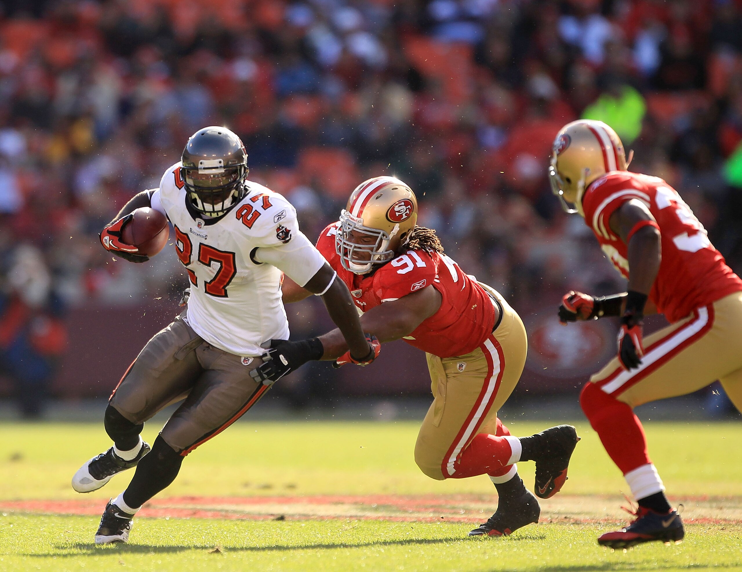 SAN FRANCISCO - NOVEMBER 21:  LeGarrette Blount #27 of the Tampa Bay Buccaneers is tackled by Ray McDonald #91 of the San Francisco 49ers at Candlestick Park on November 21, 2010 in San Francisco, California.  (Photo by Ezra Shaw/Getty Images)