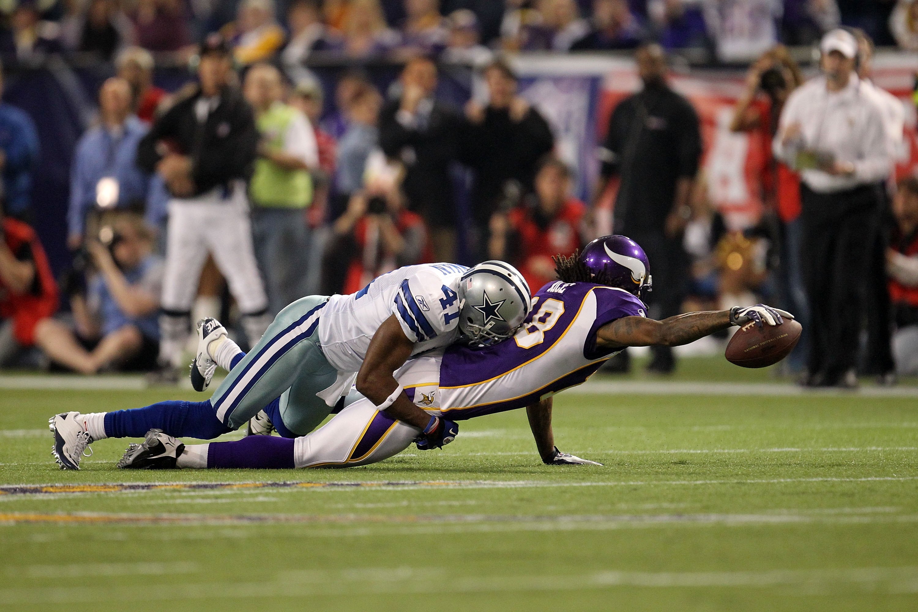 MINNEAPOLIS - JANUARY 17:  Wide receiver Sidney Rice #18 of the Minnesota Vikings is tackeled by Terence Newman #41 of the Dallas Cowboys during the NFC Divisional Playoff Game at Hubert H. Humphrey Metrodome on January 17, 2010 in Minneapolis, Minnesota.
