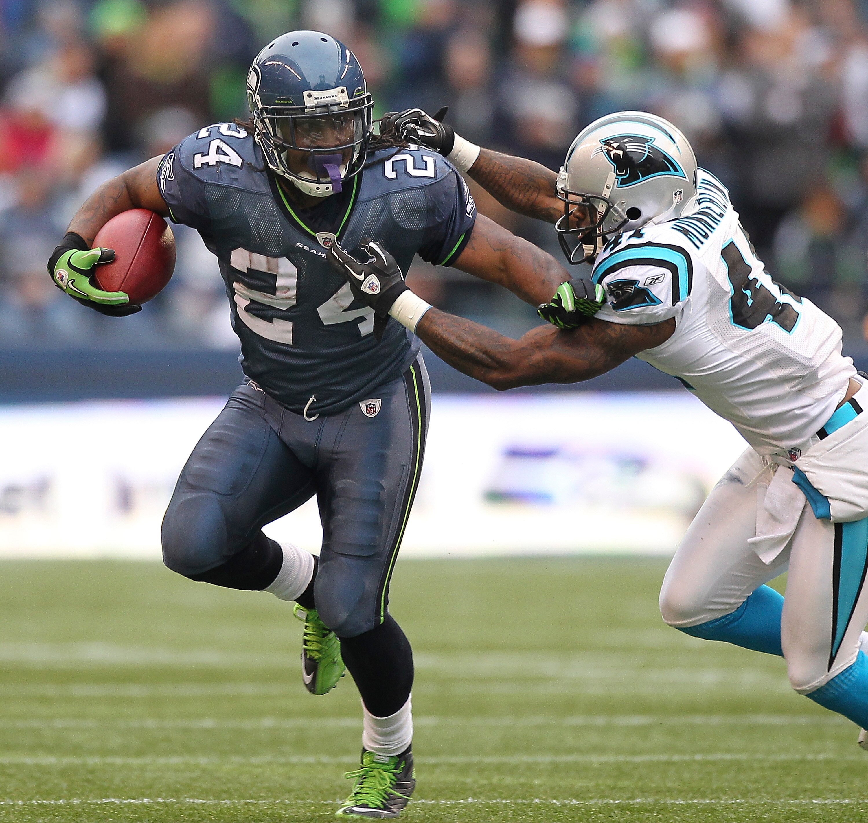 SEATTLE, WA - DECEMBER 05:  Running back Marshawn Lynch #24 of the Seattle Seahawks rushes against Captain Munnerlyn #41 of the Carolina Panthers at Qwest Field on December 5, 2010 in Seattle, Washington. The Seahawks defeated the Panthers 31-14. (Photo b