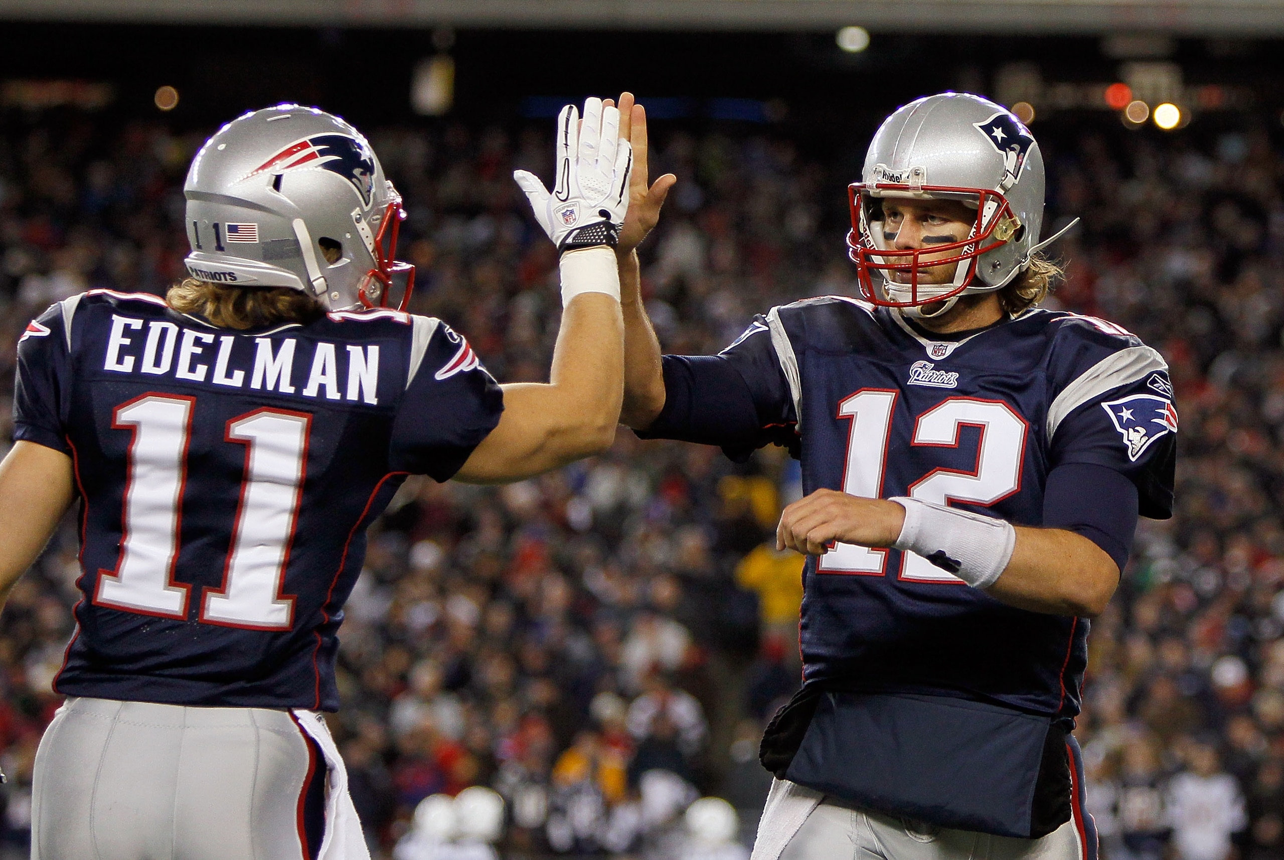 FOXBORO, MA - NOVEMBER 21: Tom Brady #12 of the New England Patriots reacts with teammate Julian Edelman #11 after a touchdown in the second half at Gillette Stadium on November 21, 2010 in Foxboro, Massachusetts. (Photo by Jim Rogash/Getty Images)