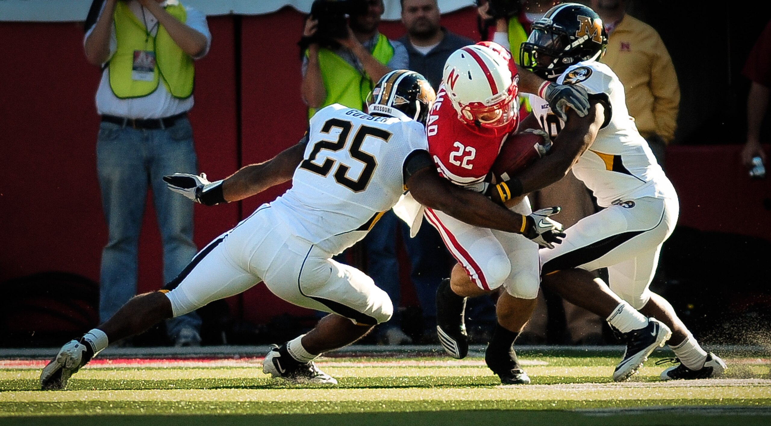 LINCOLN, NE - OCTOBER 30: Running back Rex Burkhead #22 of the Nebraska Cornhuskers fights for yardage between linebacker Zaviar Gooden #25 and defensive back Carl Gettis #19 of the Missouri Tigers during second half action of their game at Memorial Stadi