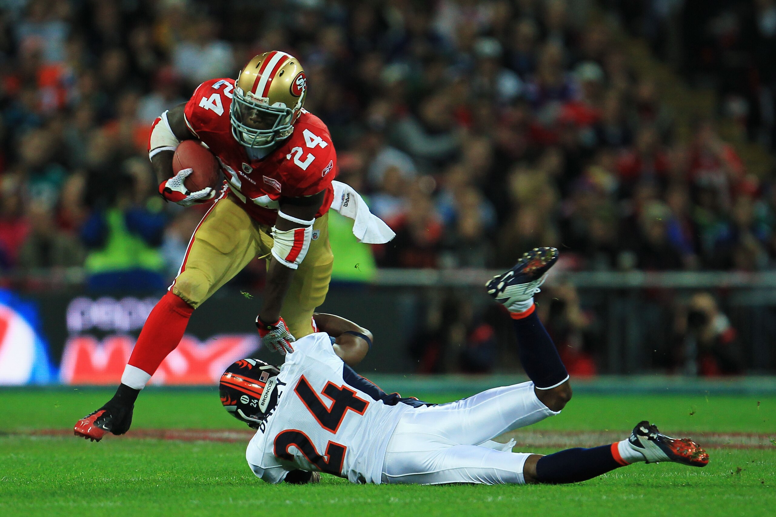 LONDON, ENGLAND - OCTOBER 31:  Anthony Dixon #24 of San Francisco 49ers is tackled by Champ Bailey #24 of Denver Broncos during the NFL International Series match between Denver Broncos and San Francisco 49ers at Wembley Stadium on October 31, 2010 in Lon