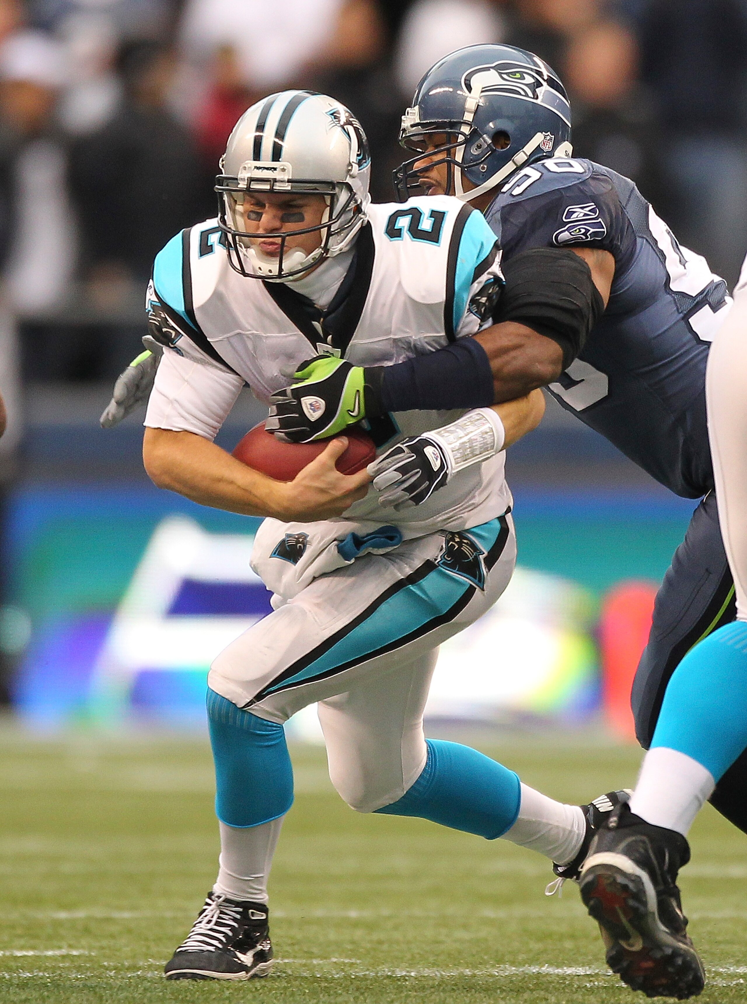 SEATTLE, WA - DECEMBER 05:  Quarterback Jimmy Clausen #2 of the Carolina Panthers is sacked by Raheem Brock #98 of the Seattle Seahawks at Qwest Field on December 5, 2010 in Seattle, Washington. The Seahawks defeated the Panthers 31-14. (Photo by Otto Gre