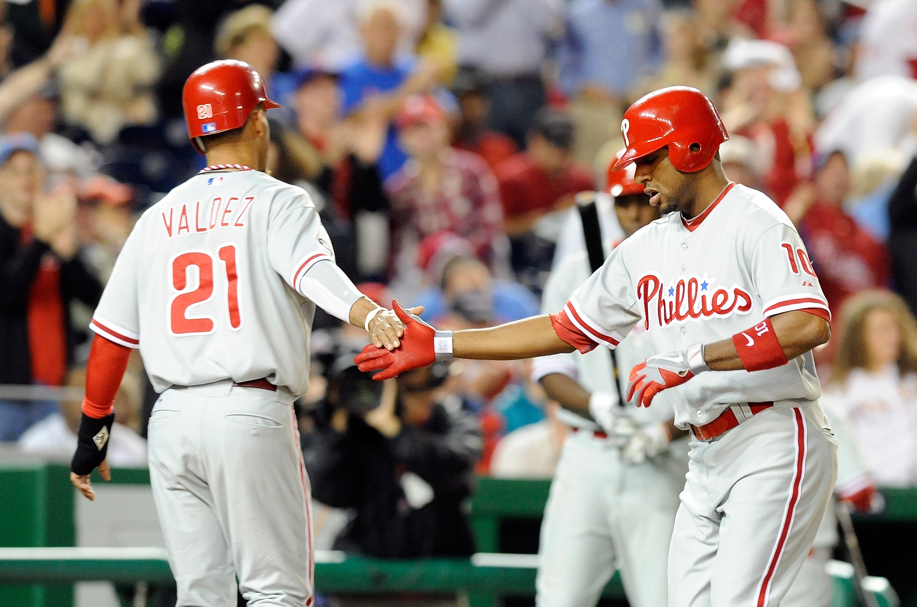 WASHINGTON - SEPTEMBER 29:  Ben Francisco #10 of the Philadelphia Phillies is congratulated by Wilson Valdez #21 after hitting a home run in the fifth inning against the Washington Nationals at Nationals Park on September 29, 2010 in Washington, DC.  (Pho