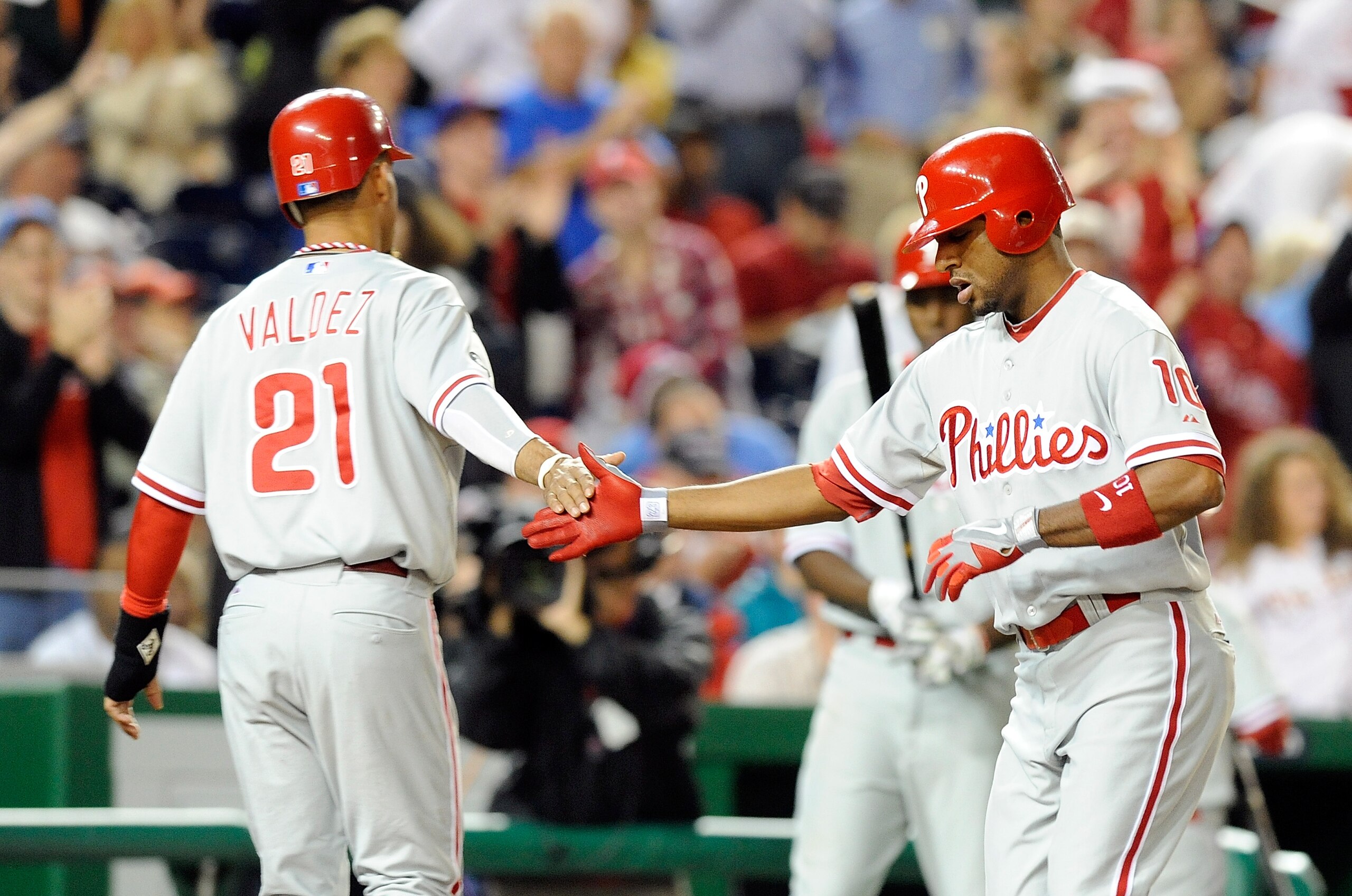 WASHINGTON - SEPTEMBER 29:  Ben Francisco #10 of the Philadelphia Phillies is congratulated by Wilson Valdez #21 after hitting a home run in the fifth inning against the Washington Nationals at Nationals Park on September 29, 2010 in Washington, DC.  (Pho
