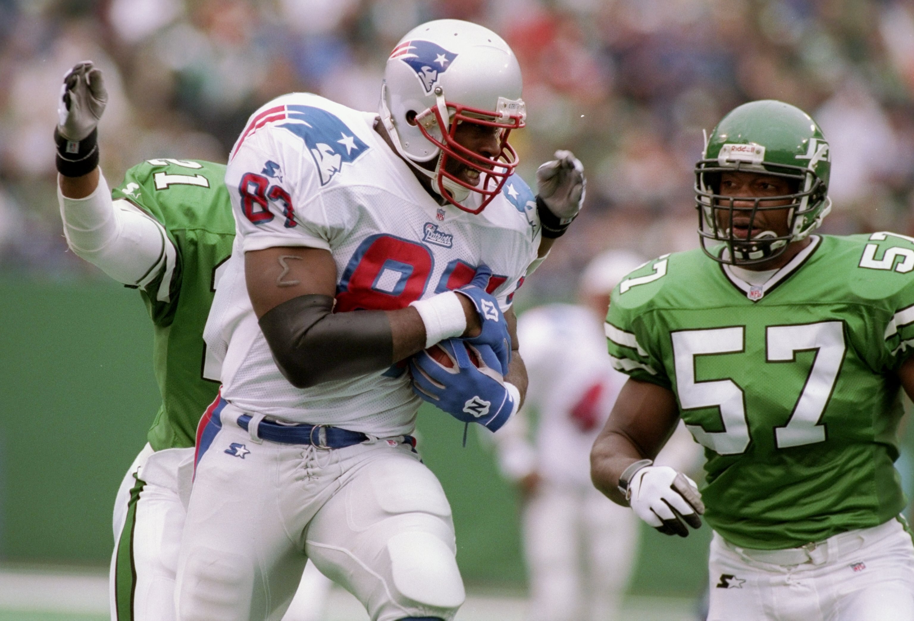 19 Oct 1997: Tight end Ben Coates of the New England Patriots runs with the ball and is chased by linebacker Mo Lewis of the New York Jets during a game at the Meadowlands in East Rutherford, New Jersey. The Jets won the game 24-19.
