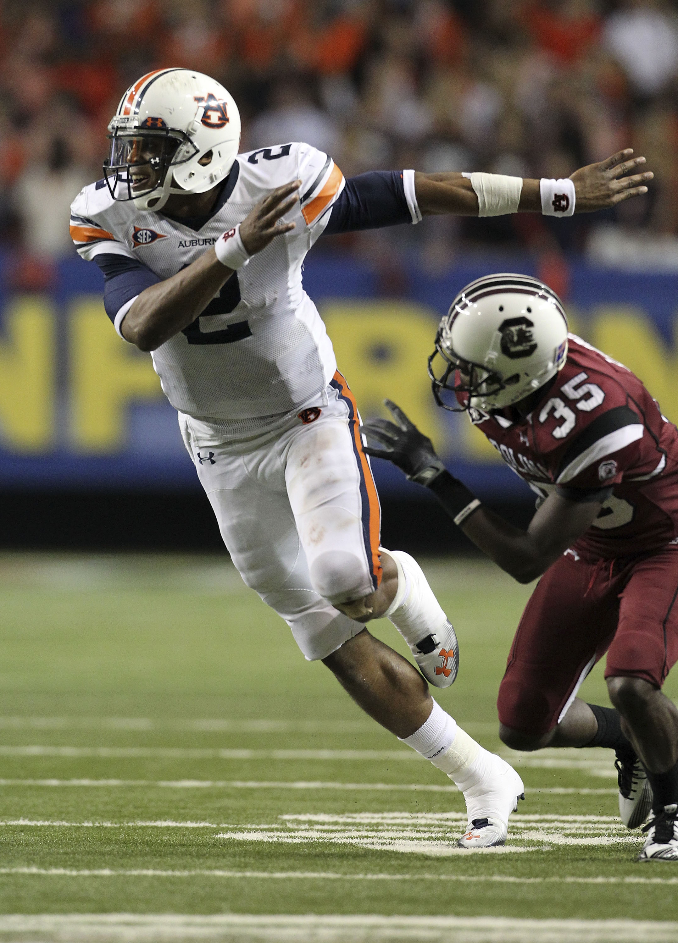 ATLANTA - DECEMBER 04:  Quarterback Cam Newton #2 of the Auburn Tigers goes out for a pass as a wide receiver while cornerback Jimmy Legree #35 of the South Carolina Gamecocks covers him during the 2010 SEC Championship at Georgia Dome on December 4, 2010