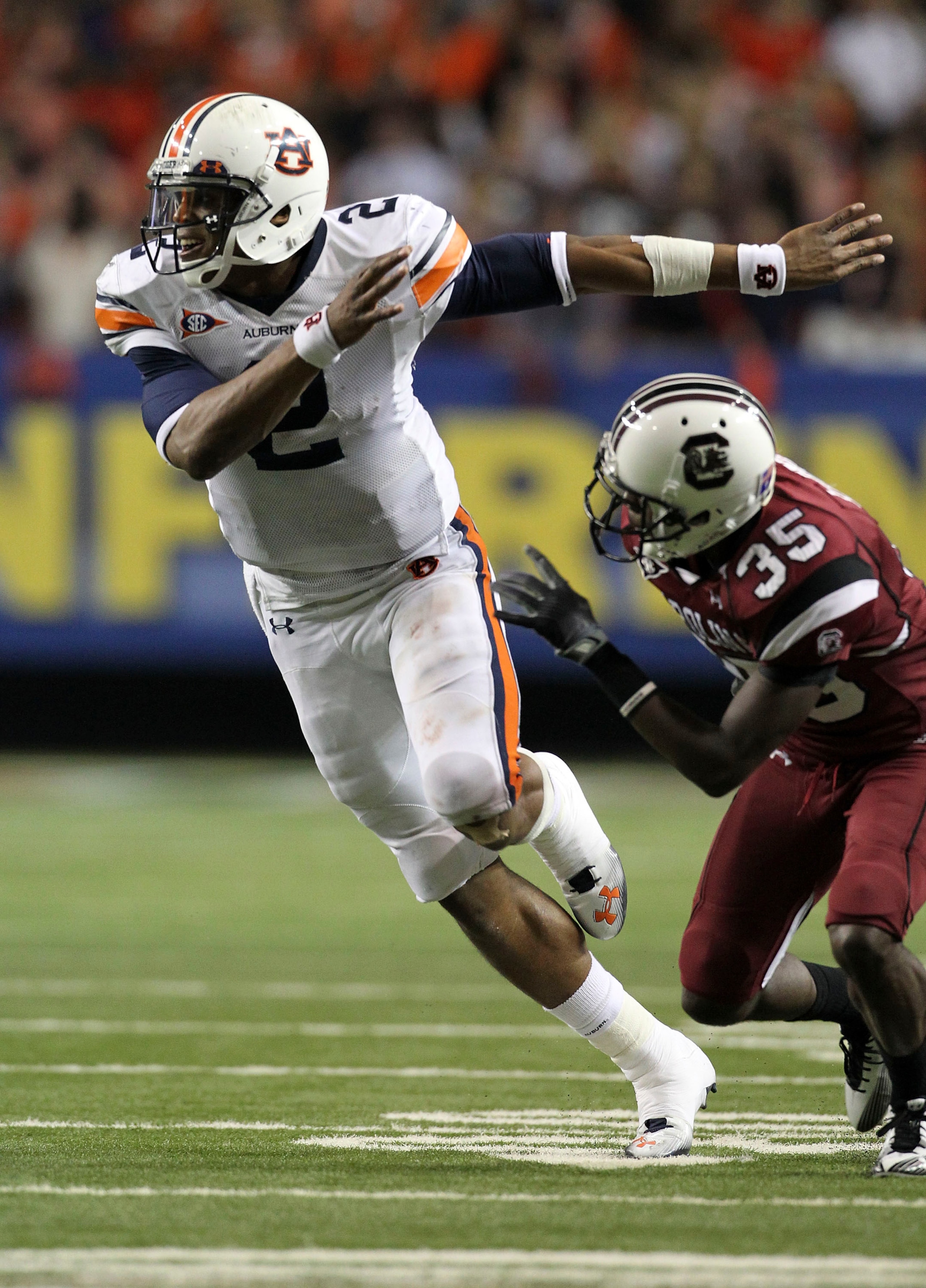 ATLANTA - DECEMBER 04: Quarterback Cam Newton #2 of the Auburn Tigers goes out for a pass as a wide receiver while cornerback Jimmy Legree #35 of the South Carolina Gamecocks covers him during the 2010 SEC Championship at Georgia Dome on December 4, 2010 ATLANTA - DECEMBER 04: Quarterback Cam Newton #2 of the Auburn Tigers goes out for a pass as a wide receiver while cornerback Jimmy Legree #35 of the South Carolina Gamecocks covers him during the 2010 SEC Championship at Georgia Dome on December 4, 2010