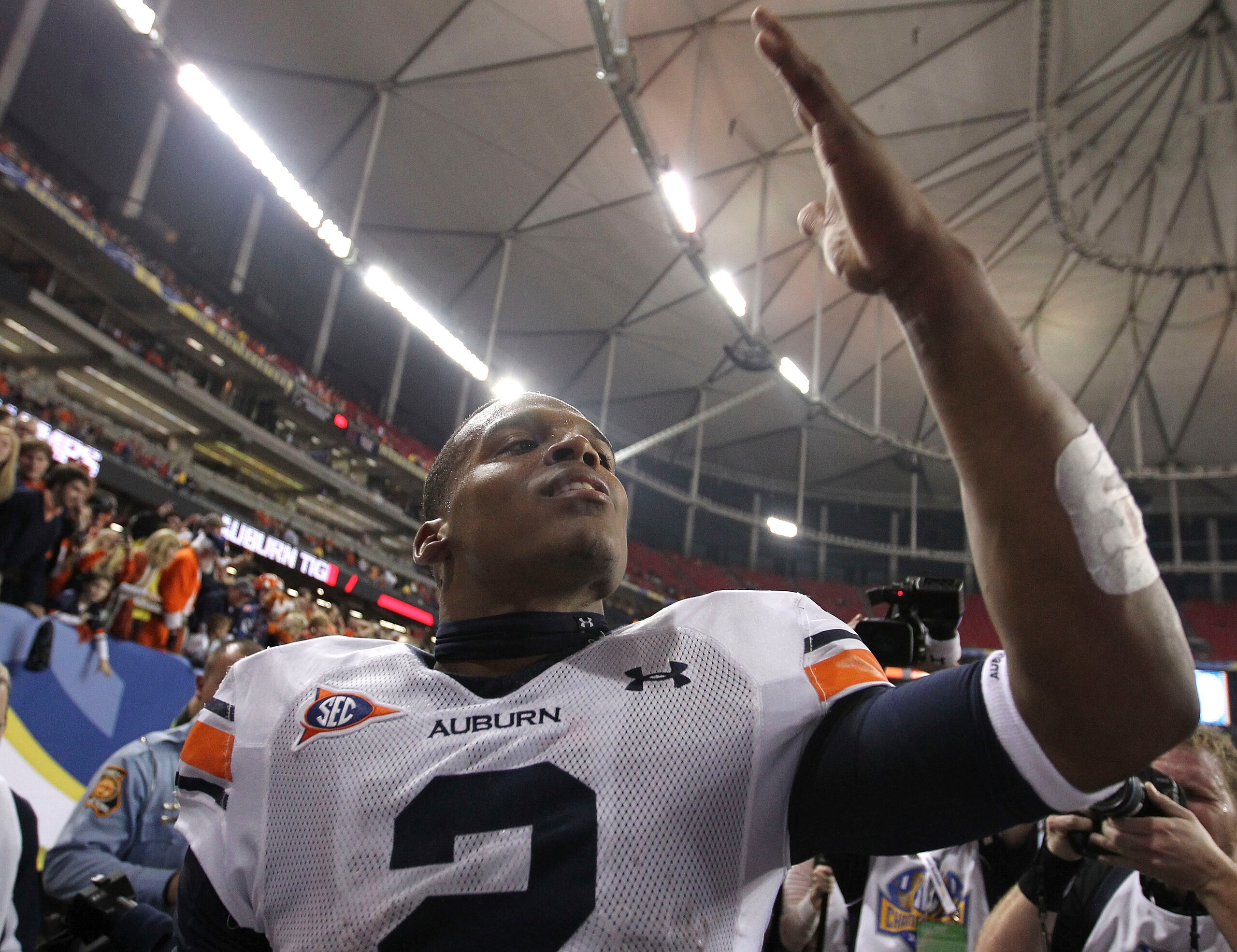 ATLANTA - DECEMBER 4: Quarterback Cam Newton #2 of the Auburn Tigers blows a kiss to the crowd after the 2010 SEC Championship against the South Carolina Gamecocks at Georgia Dome on December 4, 2010 in Atlanta, Georgia. The Tigers beat the Gamecocks 56 ATLANTA - DECEMBER 4: Quarterback Cam Newton #2 of the Auburn Tigers blows a kiss to the crowd after the 2010 SEC Championship against the South Carolina Gamecocks at Georgia Dome on December 4, 2010 in Atlanta, Georgia. The Tigers beat the Gamecocks 56