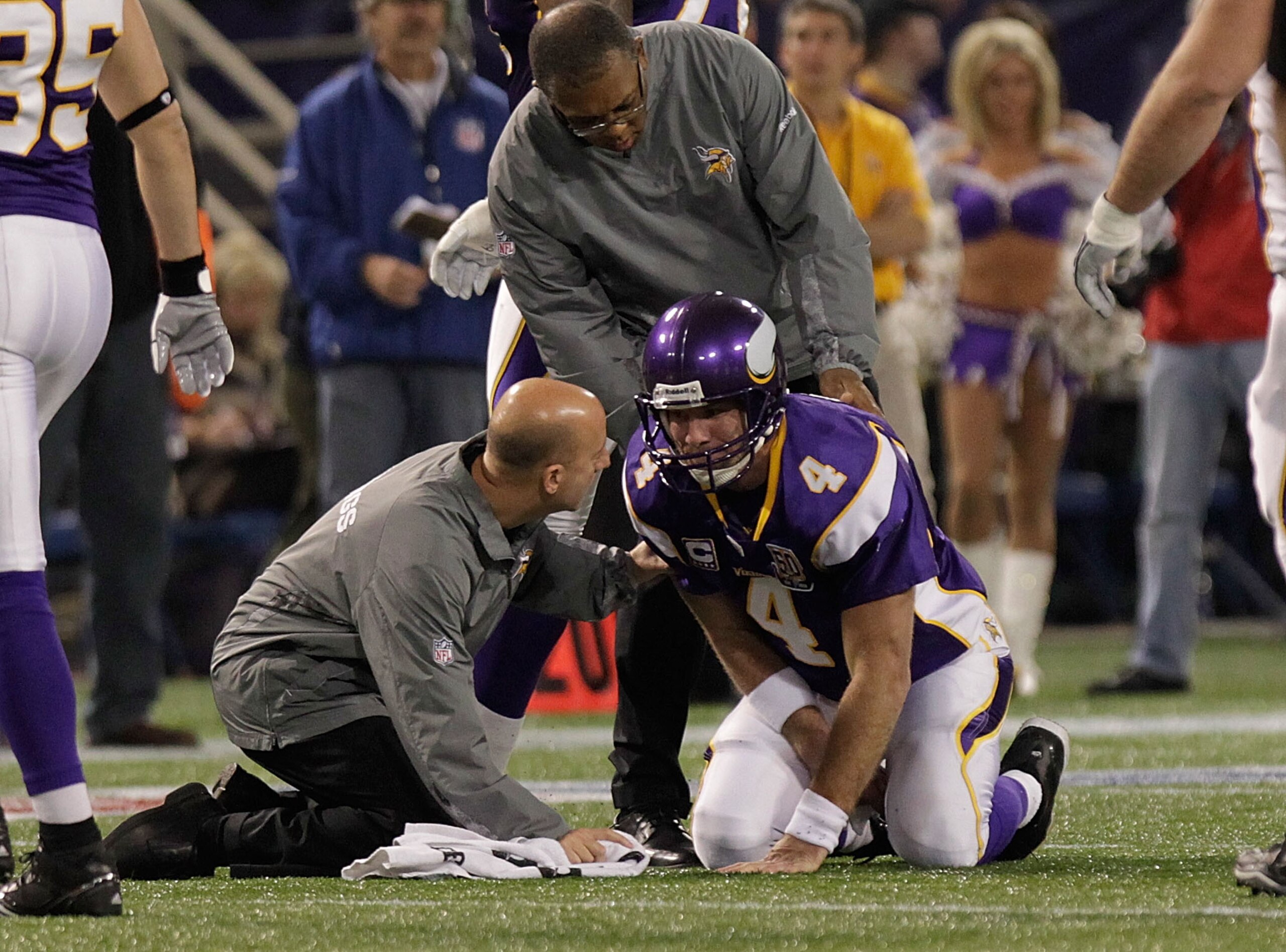 MINNEAPOLIS, MN - DECEMBER 05:  Brett Favre #4 of the Minnesota Vikings is assisted by medical staff against the Buffalo Bills defense at the Mall of America Field at the Hubert H. Humphrey Metrodome on December 5, 2010 in Minneapolis, Minnesota.  (Photo
