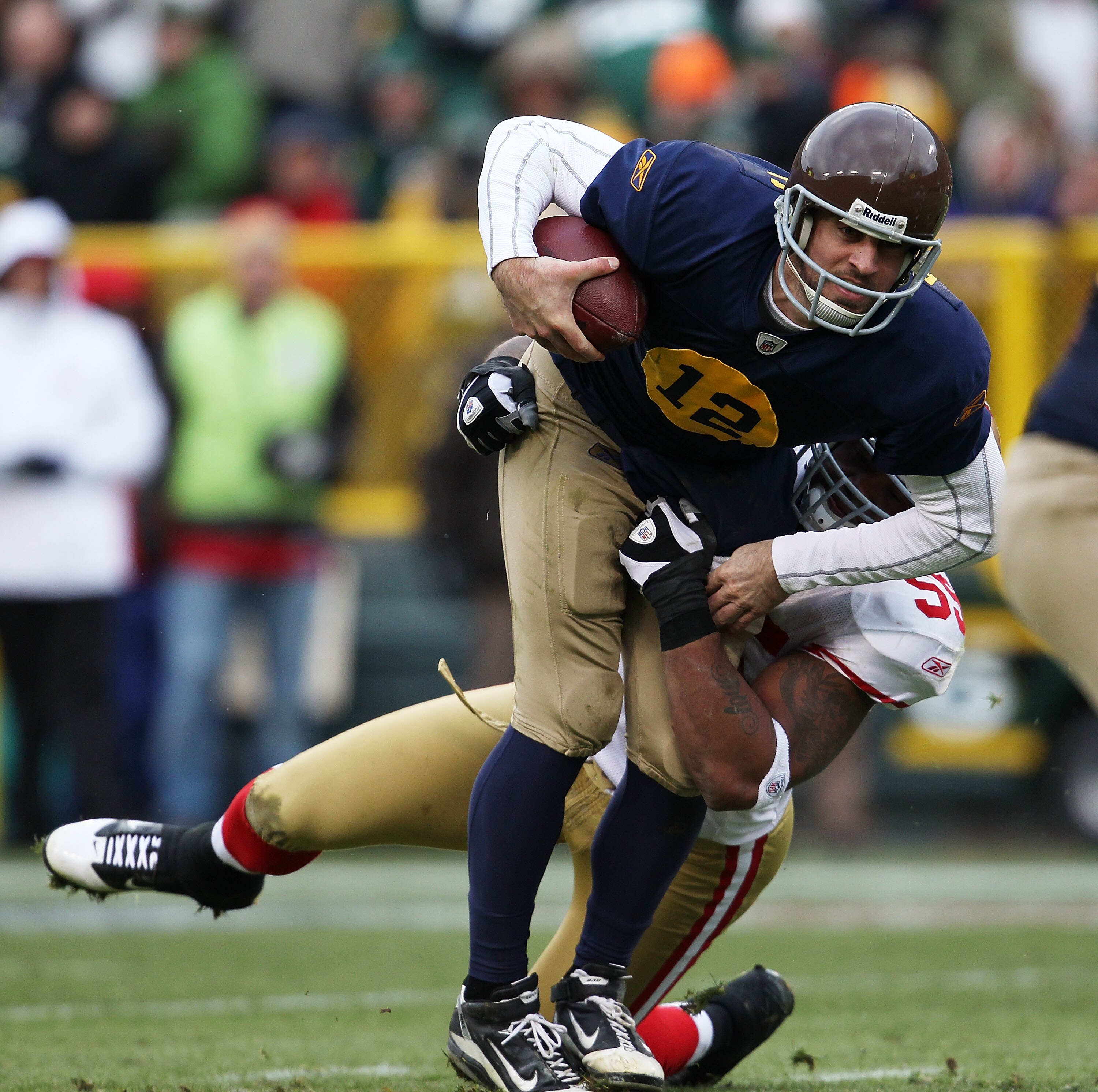 GREEN BAY, WI - DECEMBER 05: Aaron Rodgers #12 of the Green Bay Packers is sacked by Ahmad Brooks #55 of the San Francisco 49ers at Lambeau Field on December 5, 2010 in Green Bay, Wisconsin. The Packers defeated the 49ers 34-16. (Photo by Jonathan Daniel/