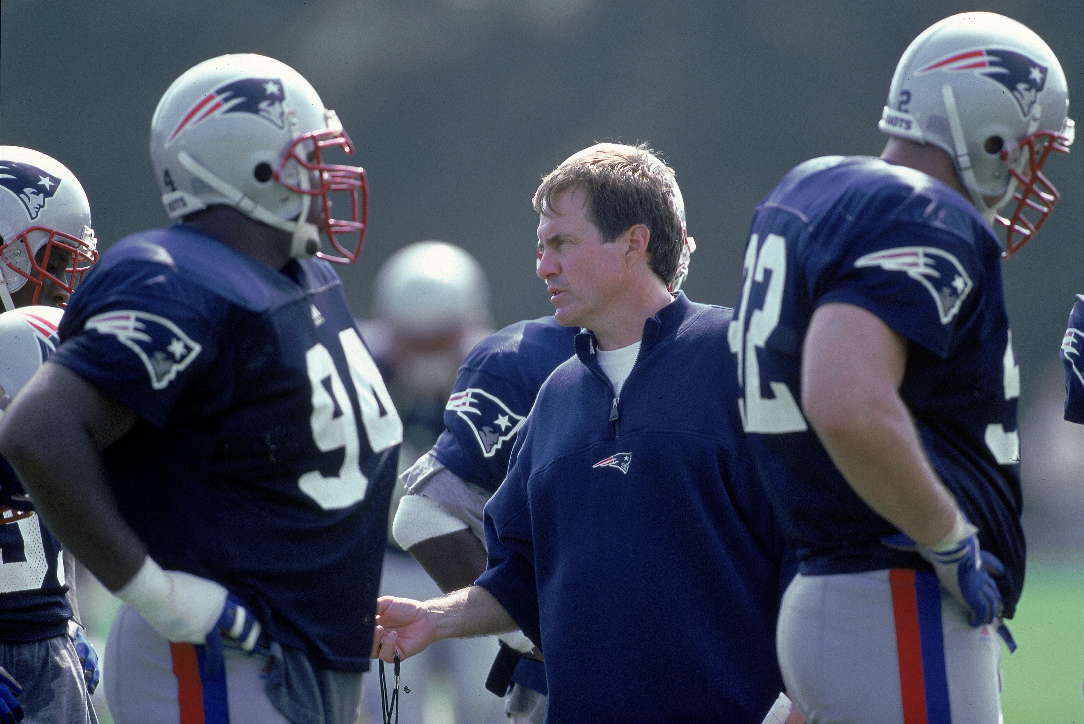 7 Aug 2000:  Head Coach Bill Belichick of the New England Patriots stands on the field amongst the players during the Patriots Training Camp at Bryant College in Smithfield, Rhode Island.Mandatory Credit: Jamie Squire  /Allsport