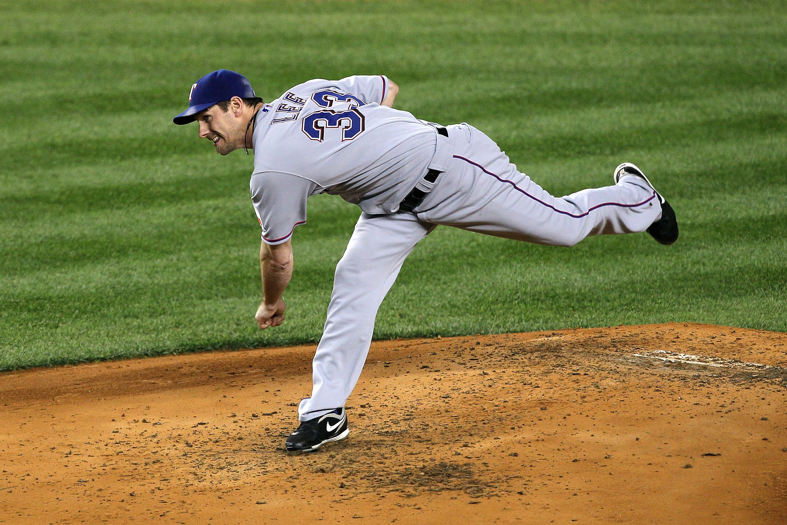 NEW YORK - OCTOBER 18:  Cliff Lee #33 of the Texas Rangers throws a pitch against the New York Yankees in Game Three of the ALCS during the 2010 MLB Playoffs at Yankee Stadium on October 18, 2010 in New York, New York. The Rangers won 8-0.  (Photo by Jim