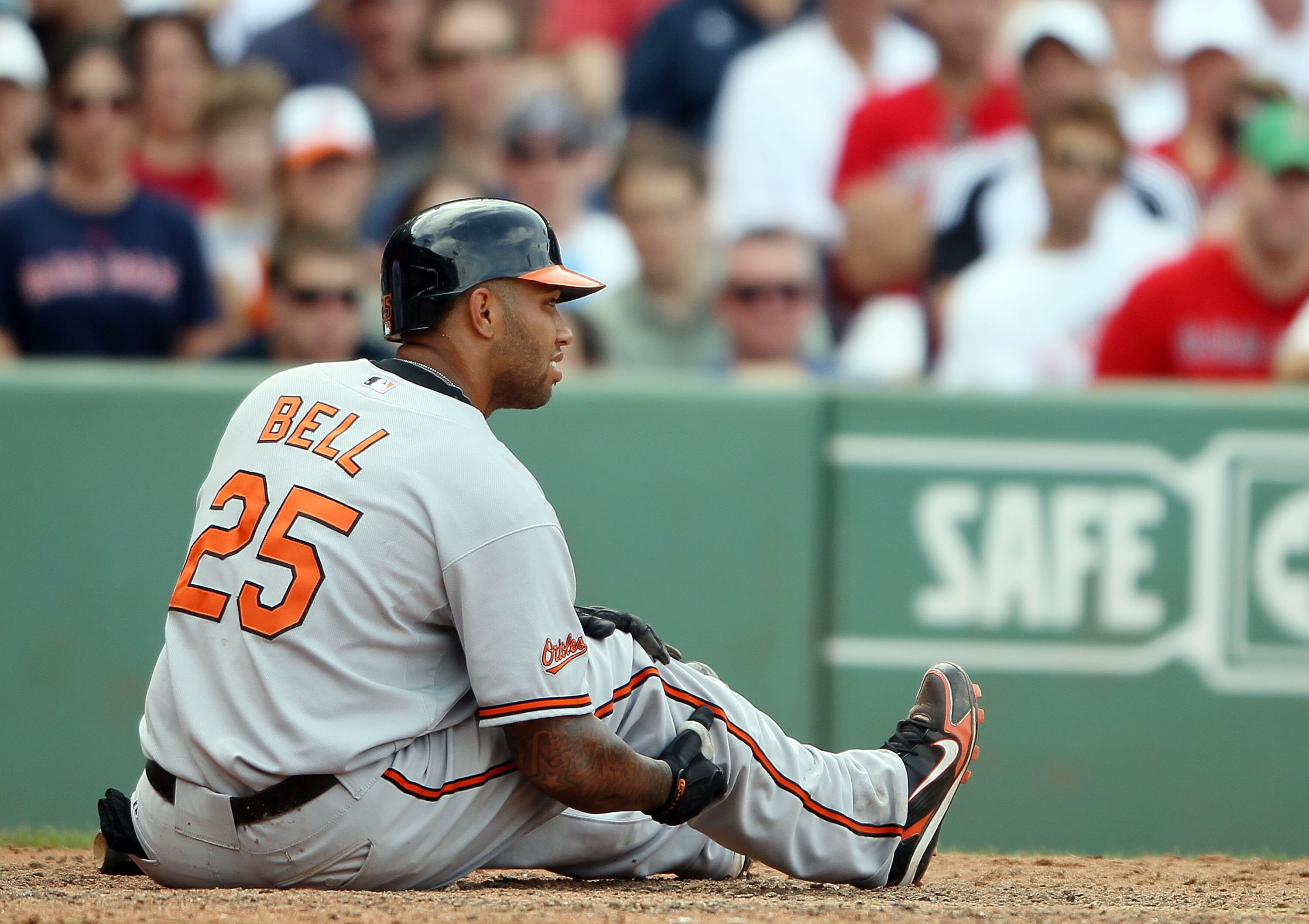 BOSTON - JULY 04:  Josh Bell #25 of the Baltimore Orioles grabs his leg after he swung the bat too hard in the eighth inning against the Boston Red Sox on July 4, 2010 at Fenway Park in Boston, Massachusetts.  (Photo by Elsa/Getty Images)