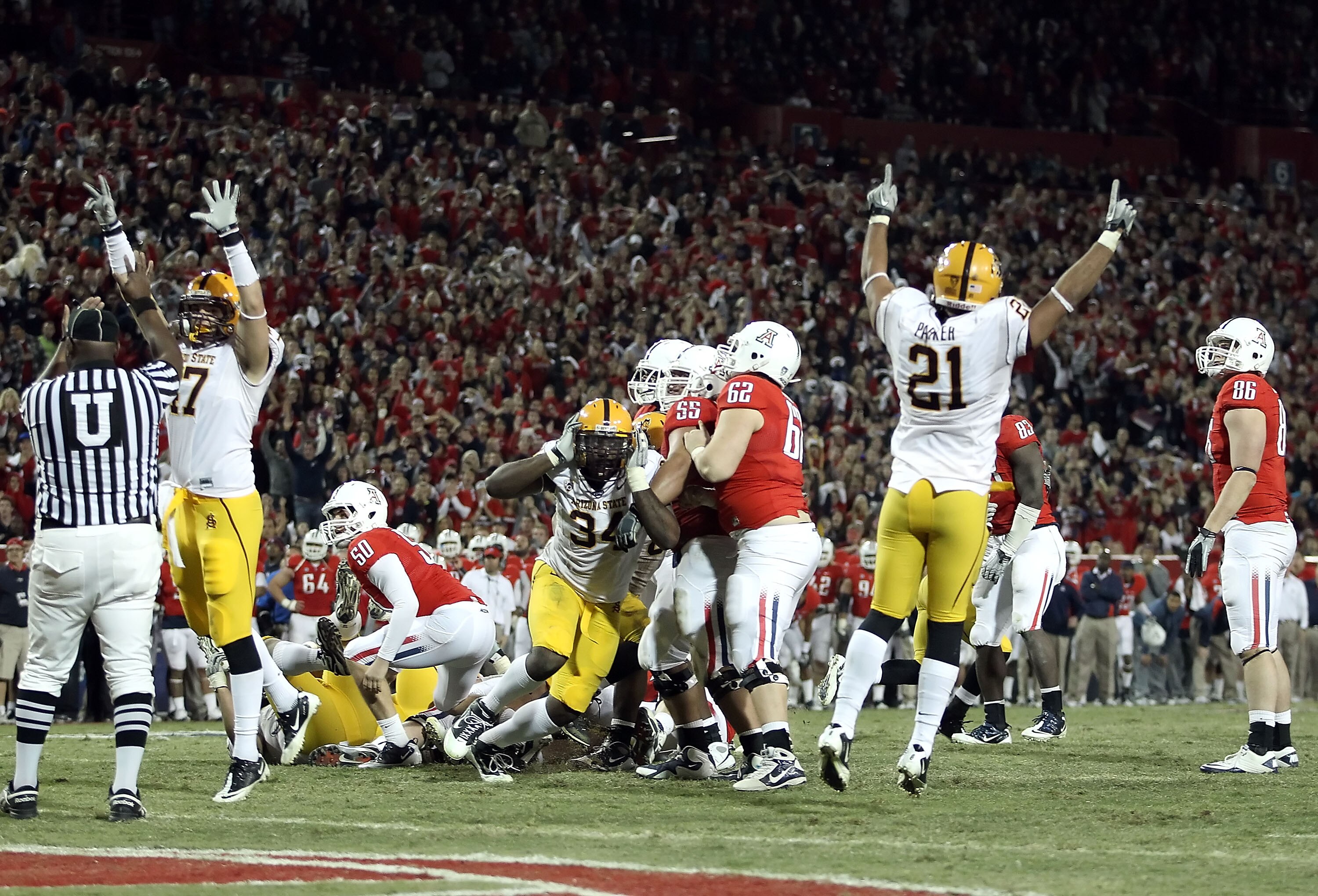 TUCSON, AZ - DECEMBER 02:  Defensive end James Brooks #34 (C) and the Arizona State Sun Devils celebrate blocking an extra point to defeat the Arizona Wildcats in double overtime of the college football game at Arizona Stadium on December 2, 2010 in Tucso