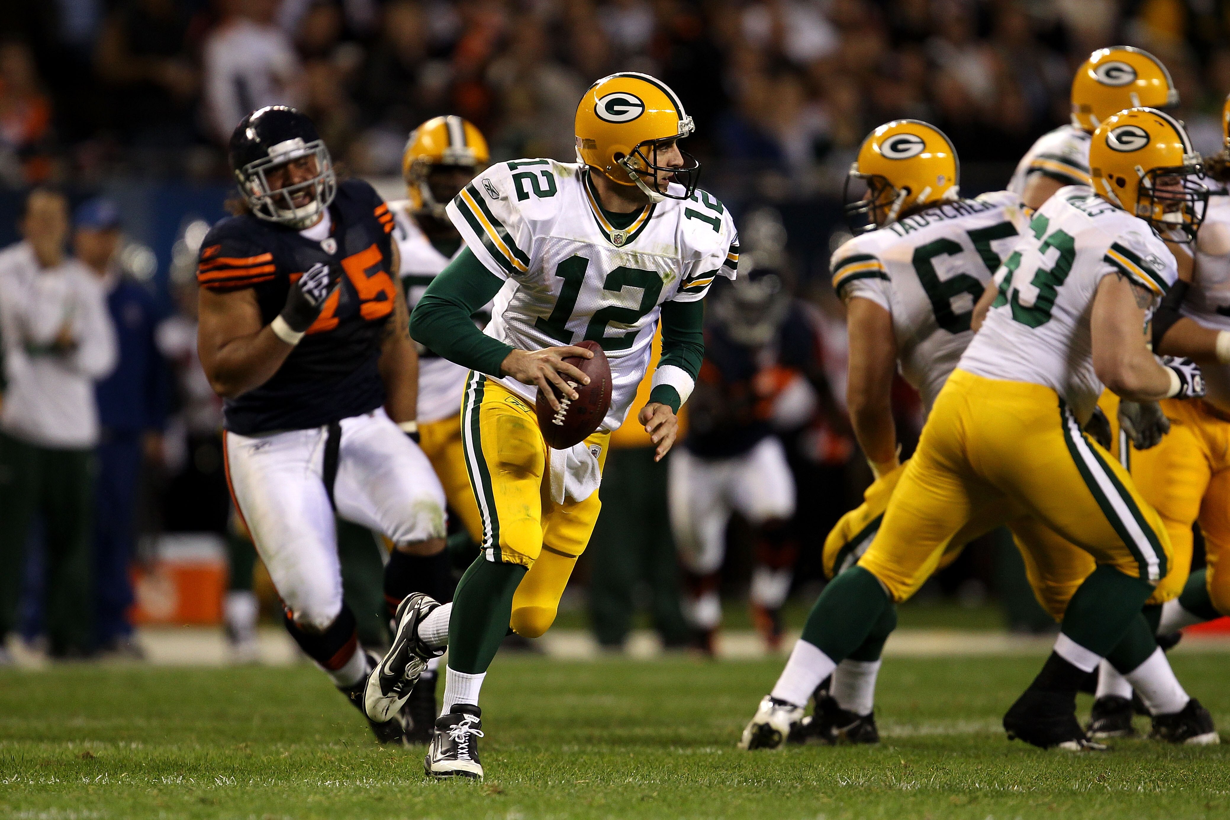 CHICAGO - SEPTEMBER 27:  Aaron Rodgers #12 of the Green Bay Packers rolls out to pass against the Chicago Bears at Soldier Field on September 27, 2010 in Chicago, Illinois. The Bears won 20-17. (Photo by Jonathan Daniel/Getty Images)