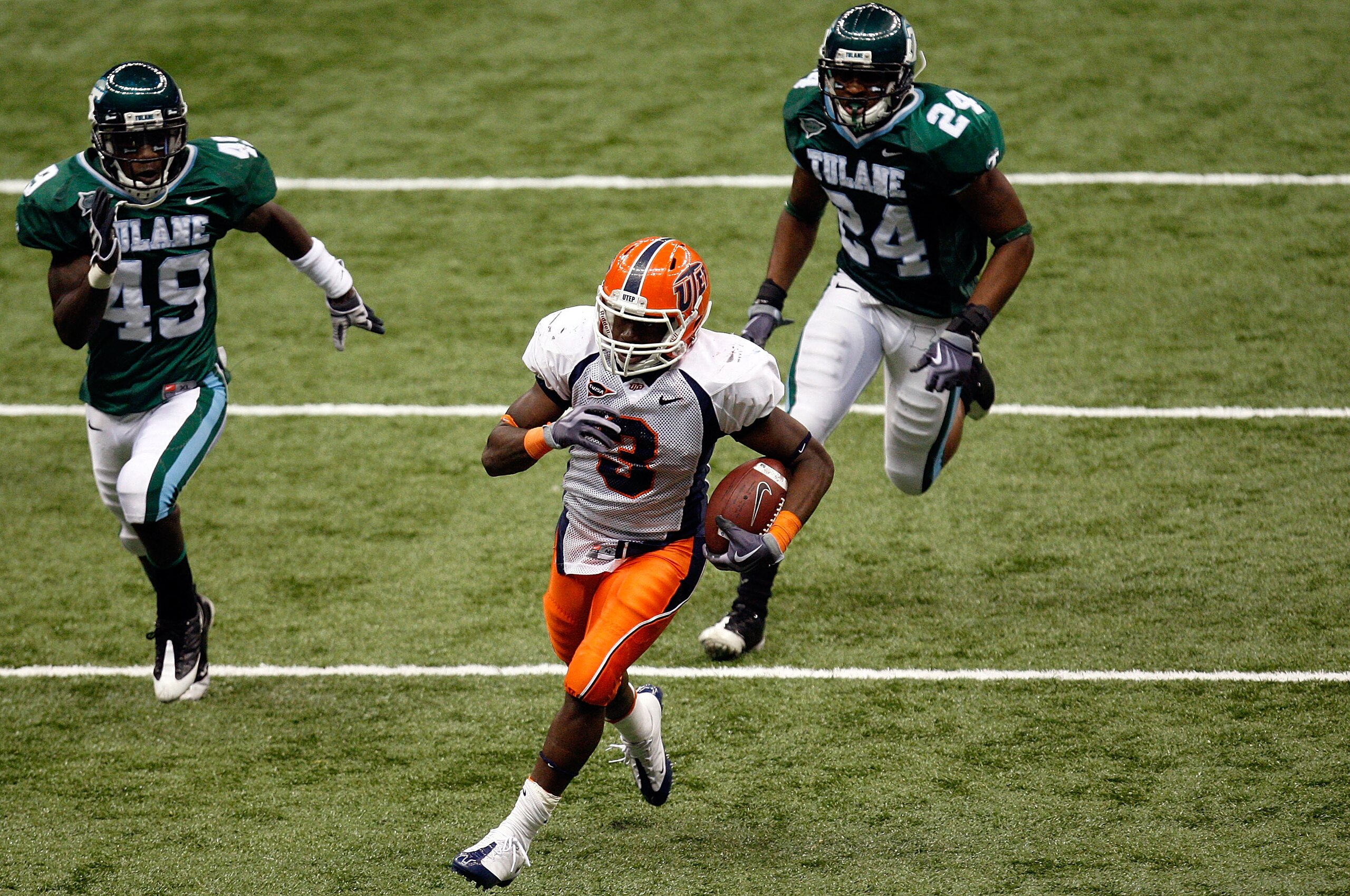 NEW ORLEANS - NOVEMBER 07:  Running back Donald Buckram #3 of the UTEP Miners runs for a touchdown past Shakiel Smith #49 and Chinonso Echebelem #24 of the Tulane Green Wave at Louisana Superdome on November 7, 2009 in New Orleans, Louisiana.  (Photo by R