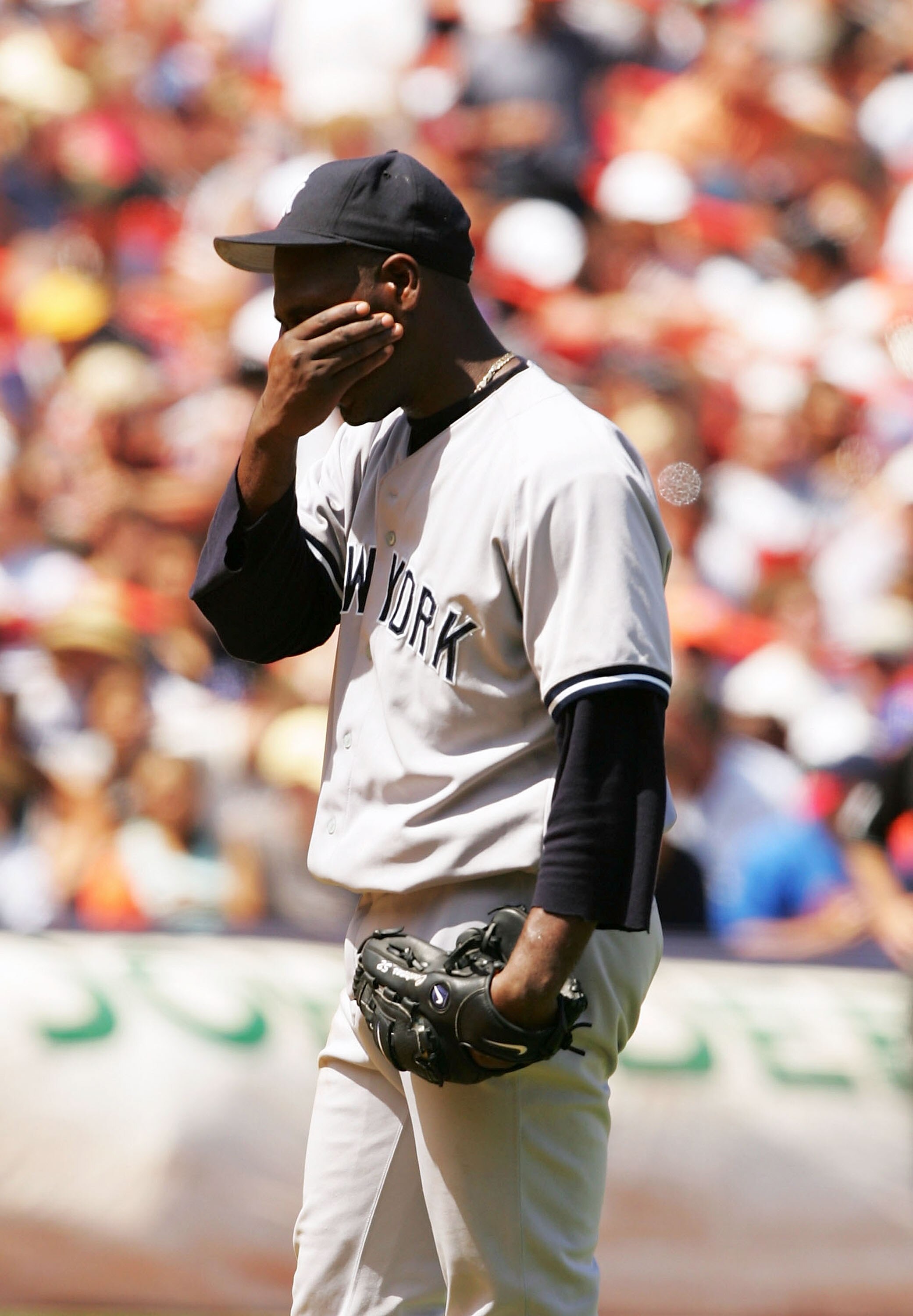 NEW YORK - JULY 3:  Starting pitcher Jose Contreras #52 of the New York Yankees covers his face after giving up a home run to Ty Wigginton of the New York Mets on July 3, 2004 at Shea Stadium in the Queens borough of New York City. The Mets beat the Yanke