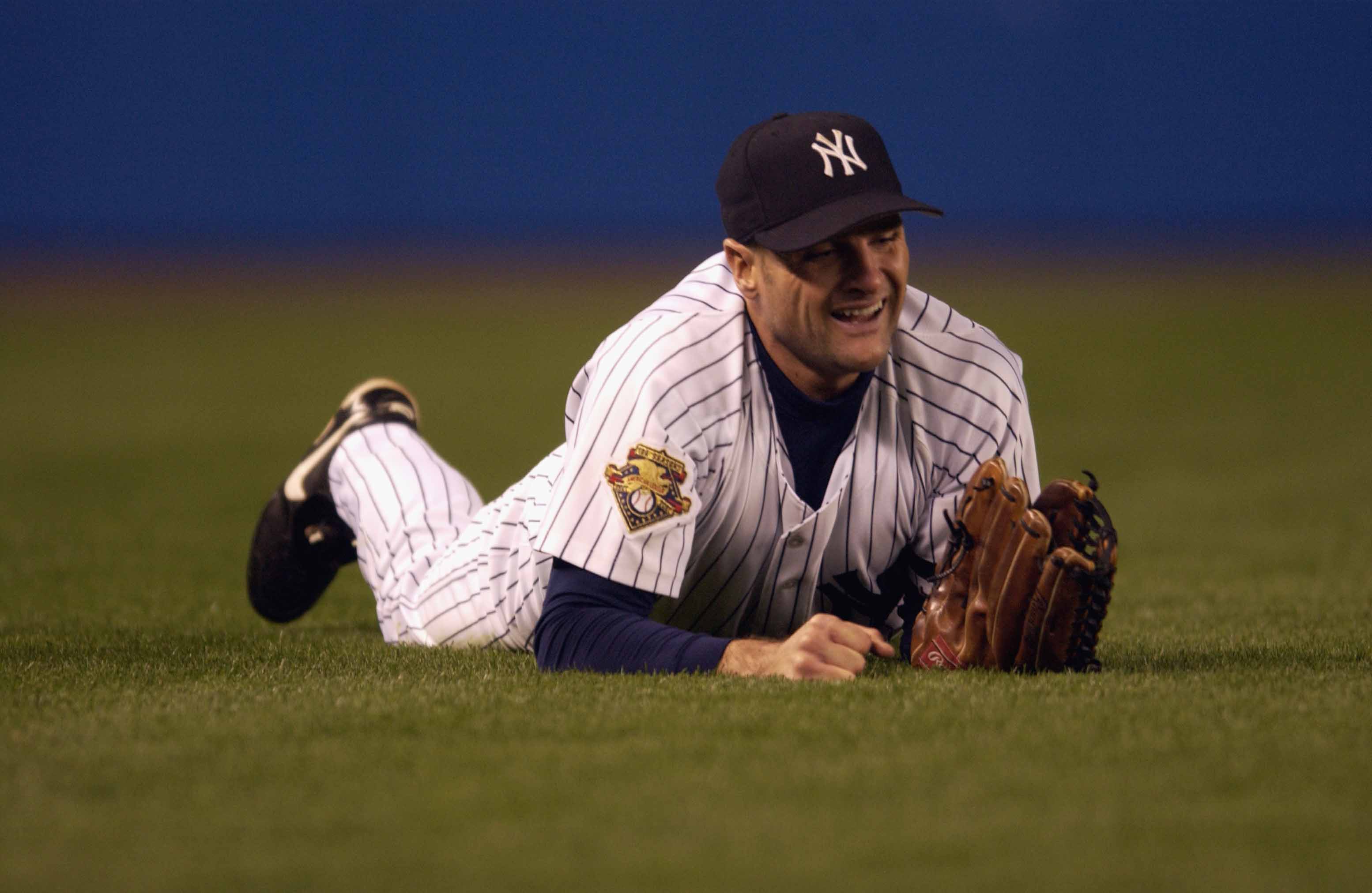 BRONX, NY - OCTOBER 22:  Leftfielder Chuck Knoblauch #11 of the New York Yankees smiles after making a diving catch for the third out against the Seattle Mariners in the bottom of the first inning of game five of the American League Championship Series on