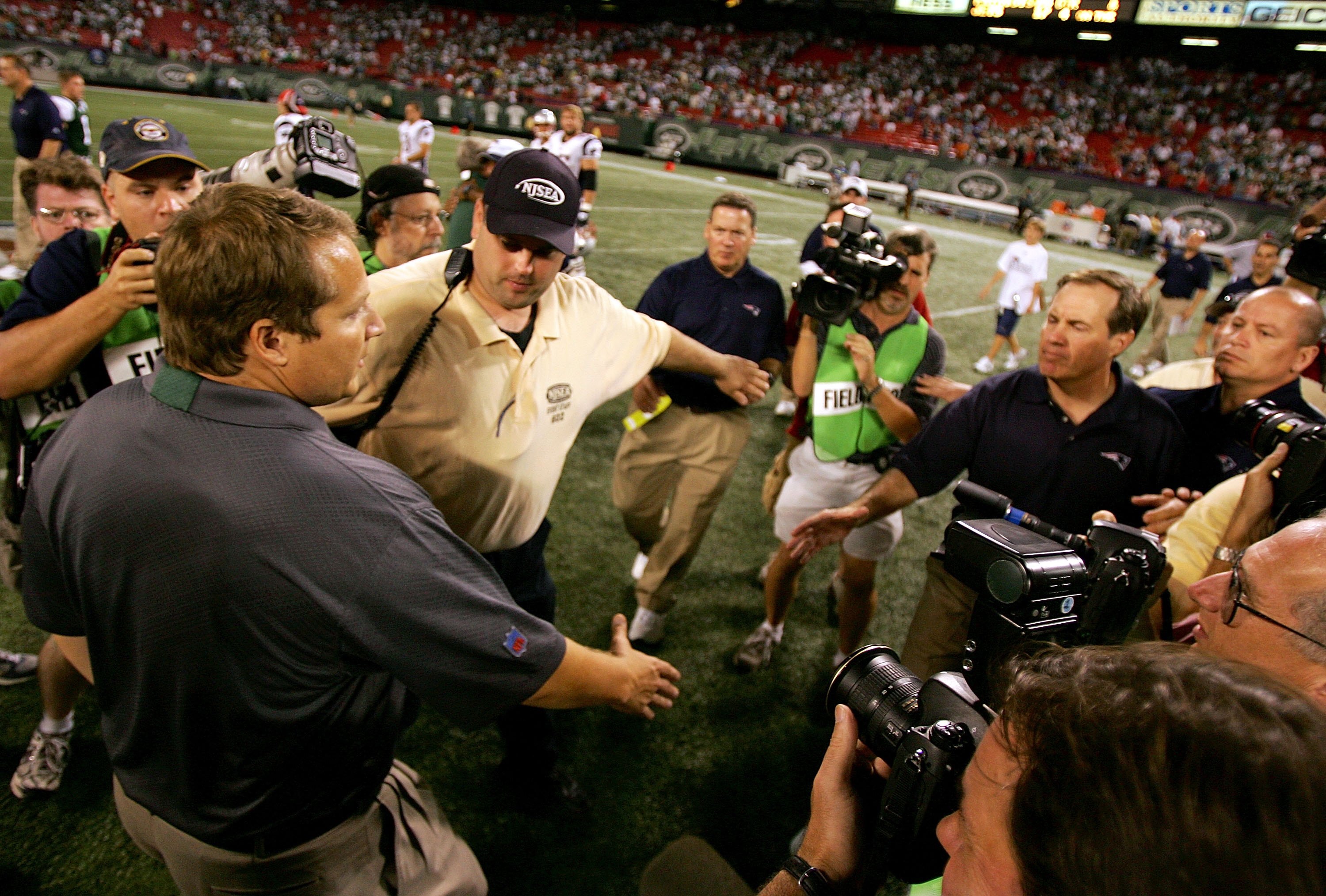 EAST RUTHERFORD, NJ - SEPTEMBER 17:  Head Coach Eric Mangini of the New York Jets congratulates head coach Bill Belichick of the New England Patriots after the Patriots won the game 24-17 on September 17, 2006 at Giants Stadium in East Rutherford, New Jer