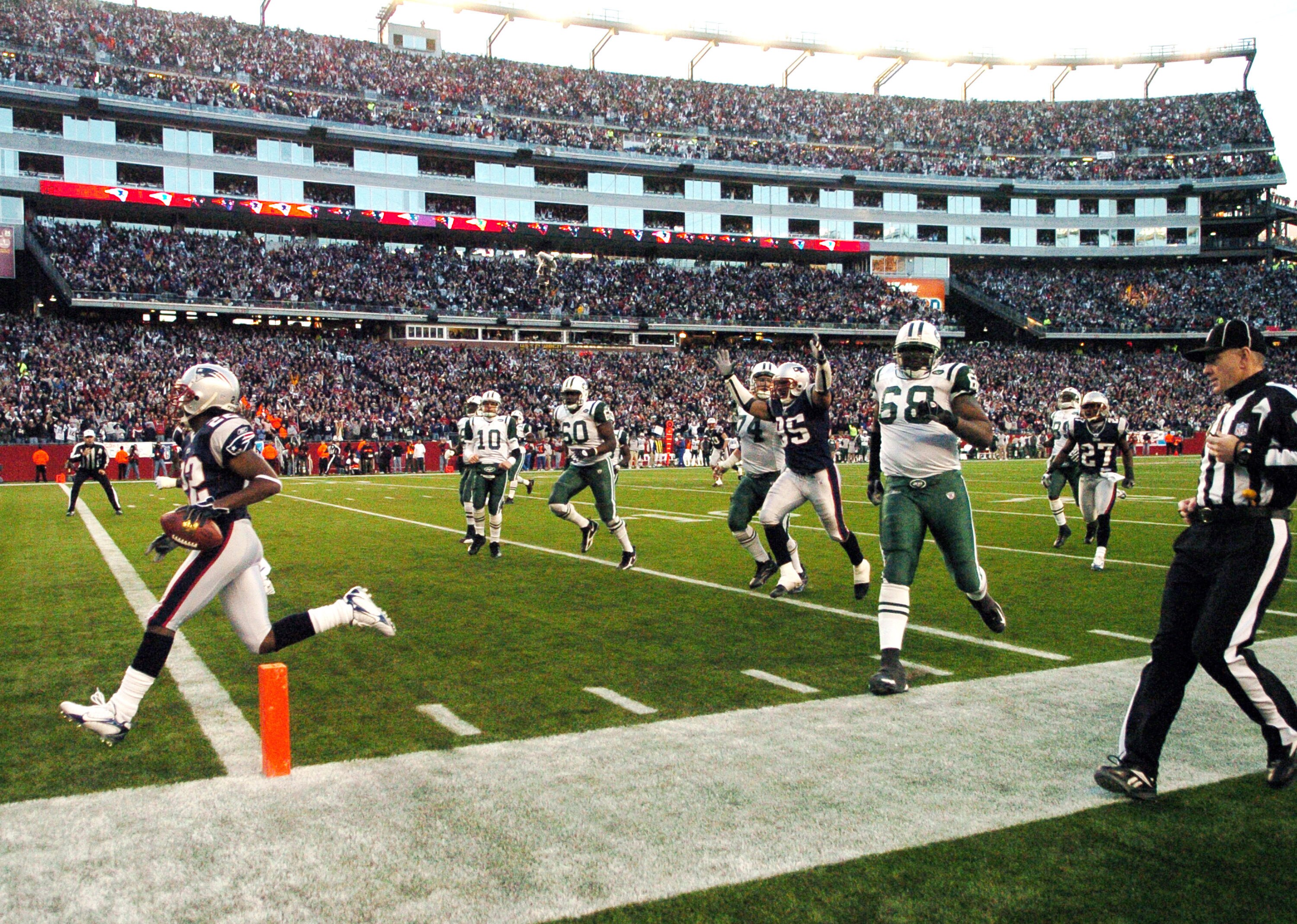 New England Patriots cornerback Asante Samuel intercepts a pass and crosses the goal line  for a touchdown  against the New York Jets  during  an NFL wild card playoff game Jan. 7, 2007 in Foxborough.  The Pats won 37 - 16. (Photo by Al Messerschmidt/Gett