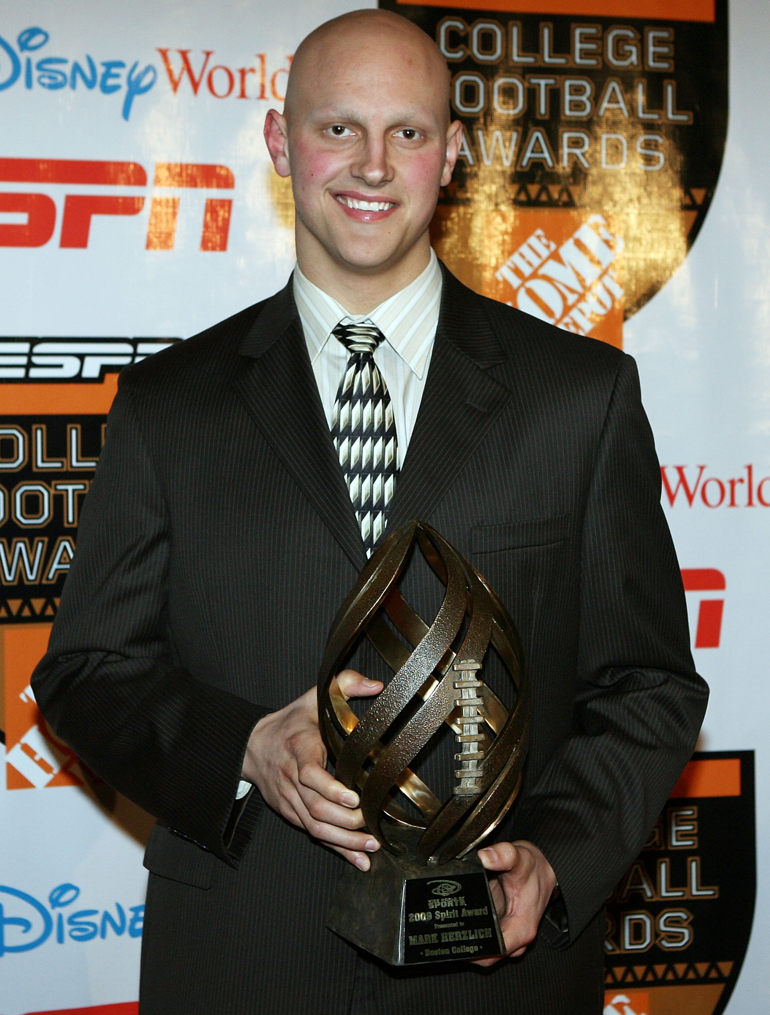 LAKE BUENA VISTA, FL - DECEMBER 10:  Defensive lineman Mark Herzlich of the Boston College poses with the Disney Spirit Award trophy during the Home Depot ESPNU College Football Awards at the Disney Boardwalk on December 10, 2009 in Lake Buena Vista, Flor