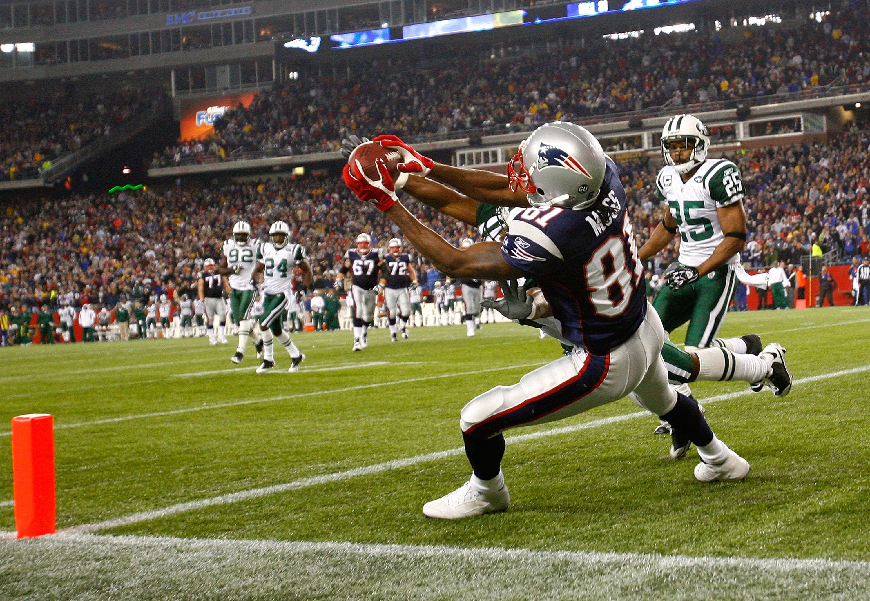 FOXBORO, MA - NOVEMBER 13: Randy Moss #81 of the New England Patriots catches a touchdown pass against the defense of Ty Law #22 and Kerry Rhodes #25 of the New York Jets at Gillette Stadium on November 13, 2008 in Foxboro, Massachusetts. The Jets won 34-