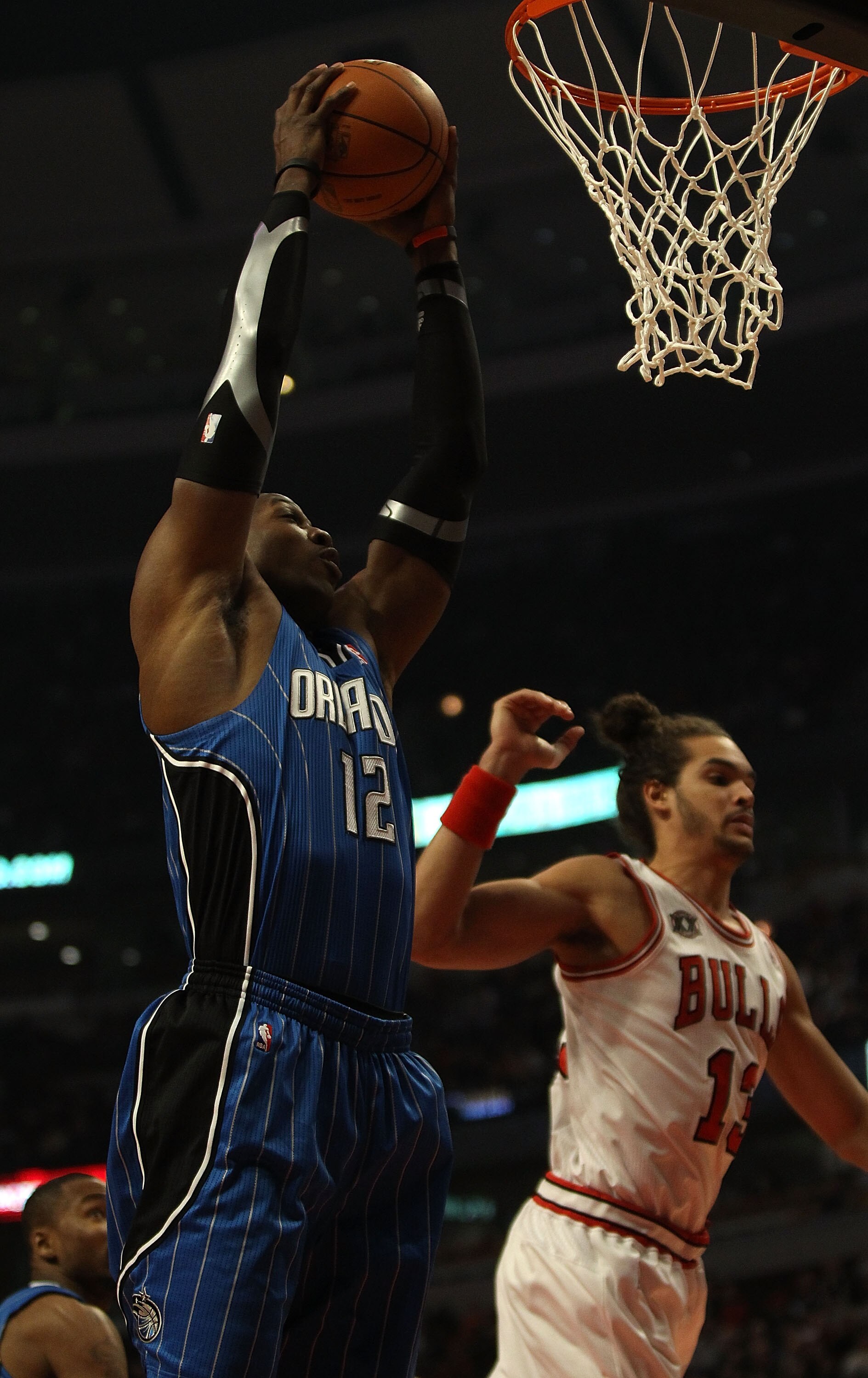 CHICAGO, IL - DECEMBER 01: Dwight Howard #12 of the Orlando Magic grabs a rebound near Joakim Noah #13 of the Chicago Bulls at the United Center on December 1, 2010 in Chicago, Illinois. NOTE TO USER: User expressly acknowledges and agrees that, by downlo