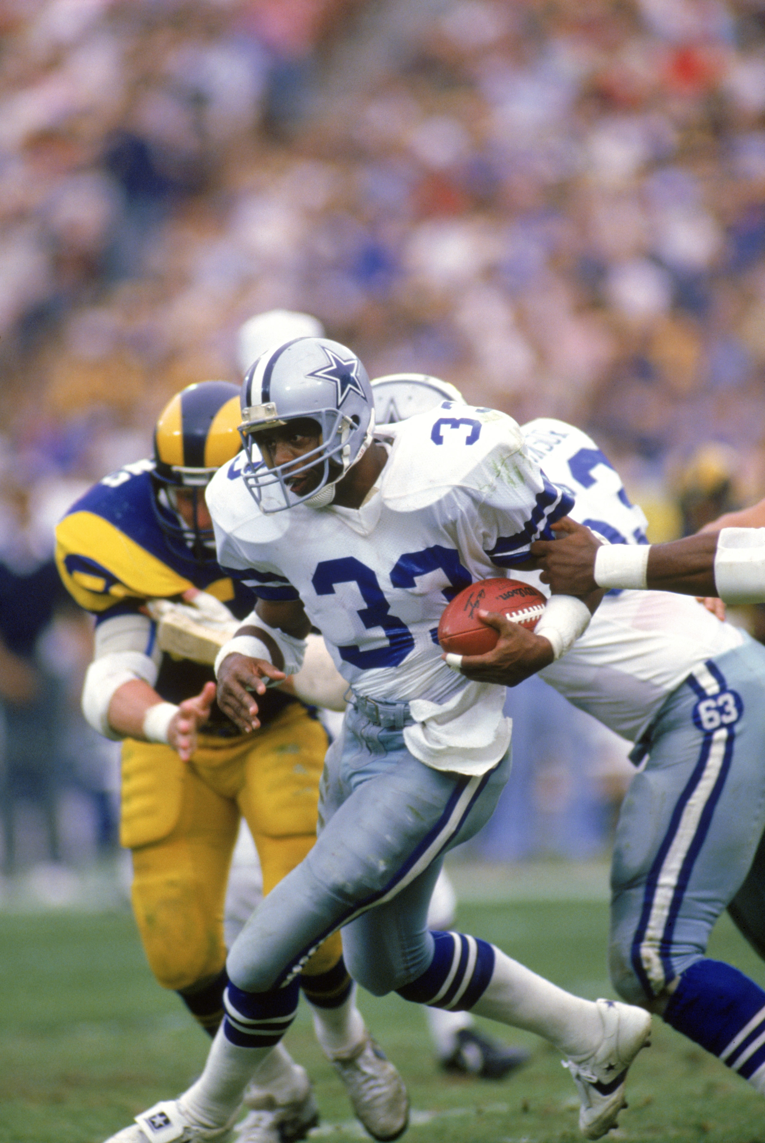 ANAHEIM, CA - JANUARY 4:  Running back Tony Dorsett #33 of the Dallas Cowboys rushes for yards during a 1985 NFC Divisional Playoff game against the Los Angeles Rams at Anaheim Stadium on January 4, 1996 in Anaheim, California.  The Rams won 20-0.  (Photo