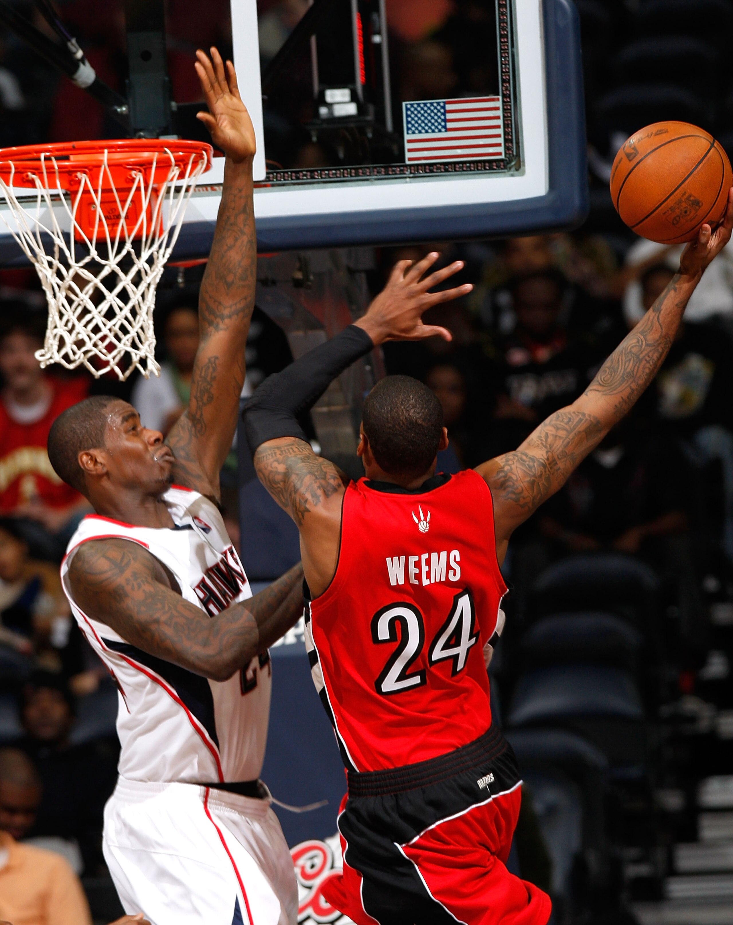 ATLANTA - DECEMBER 02:  Marvin Williams #24 of the Atlanta Hawks defends the basket against Sonny Weems #24 of the Toronto Raptors at Philips Arena on December 2, 2009 in Atlanta, Georgia.  NOTE TO USER: User expressly acknowledges and agrees that, by dow