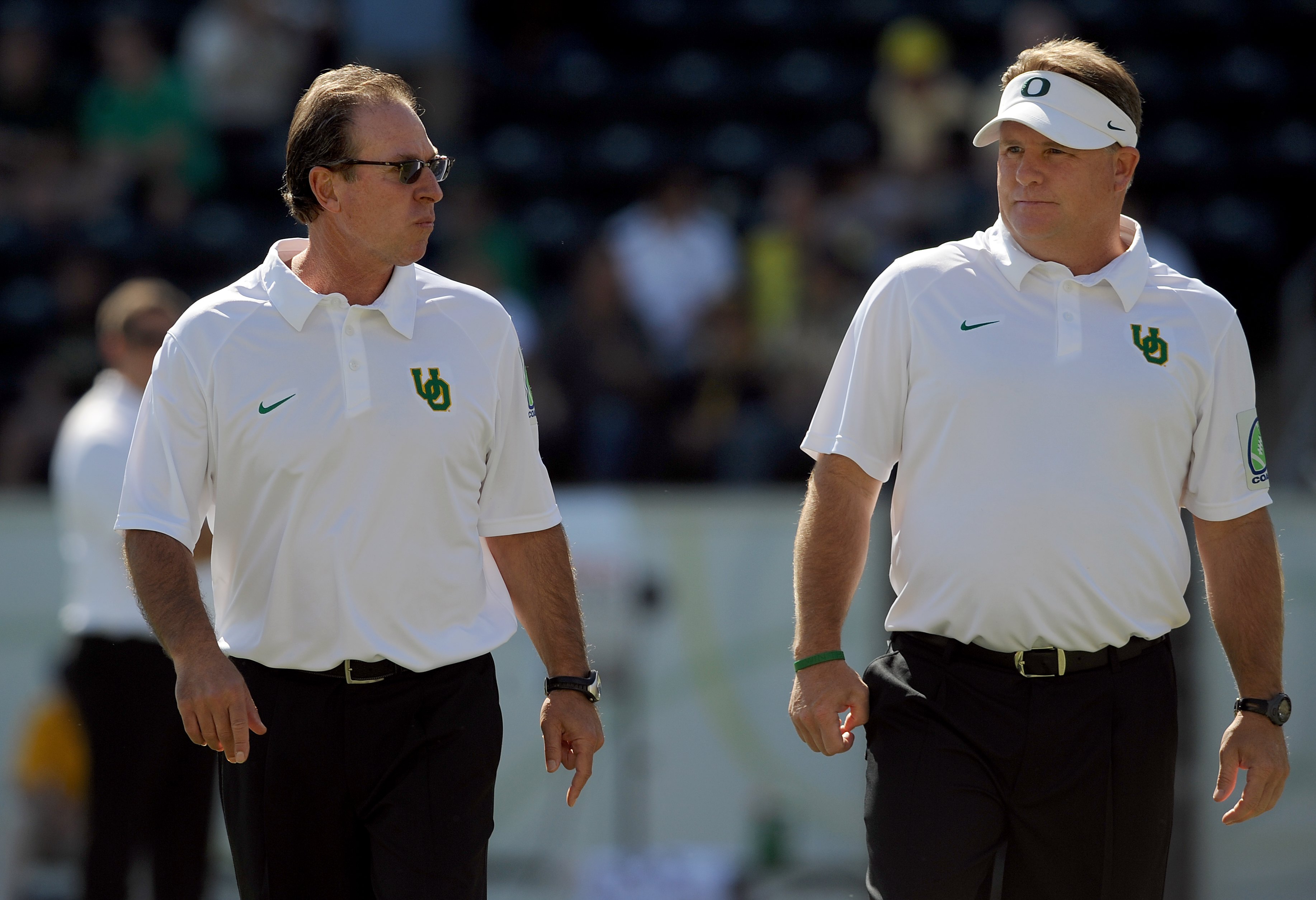 EUGENE, OR - SEPTEMBER 26: (L to R) Defensive coordinator Nick Aliotti and head coach Chip Kelly of the Oregon Ducks speak before the game against the California Bears at Autzen Stadium on September 26, 2009 in Eugene, Oregon. Oregon won the game 42-3.  (