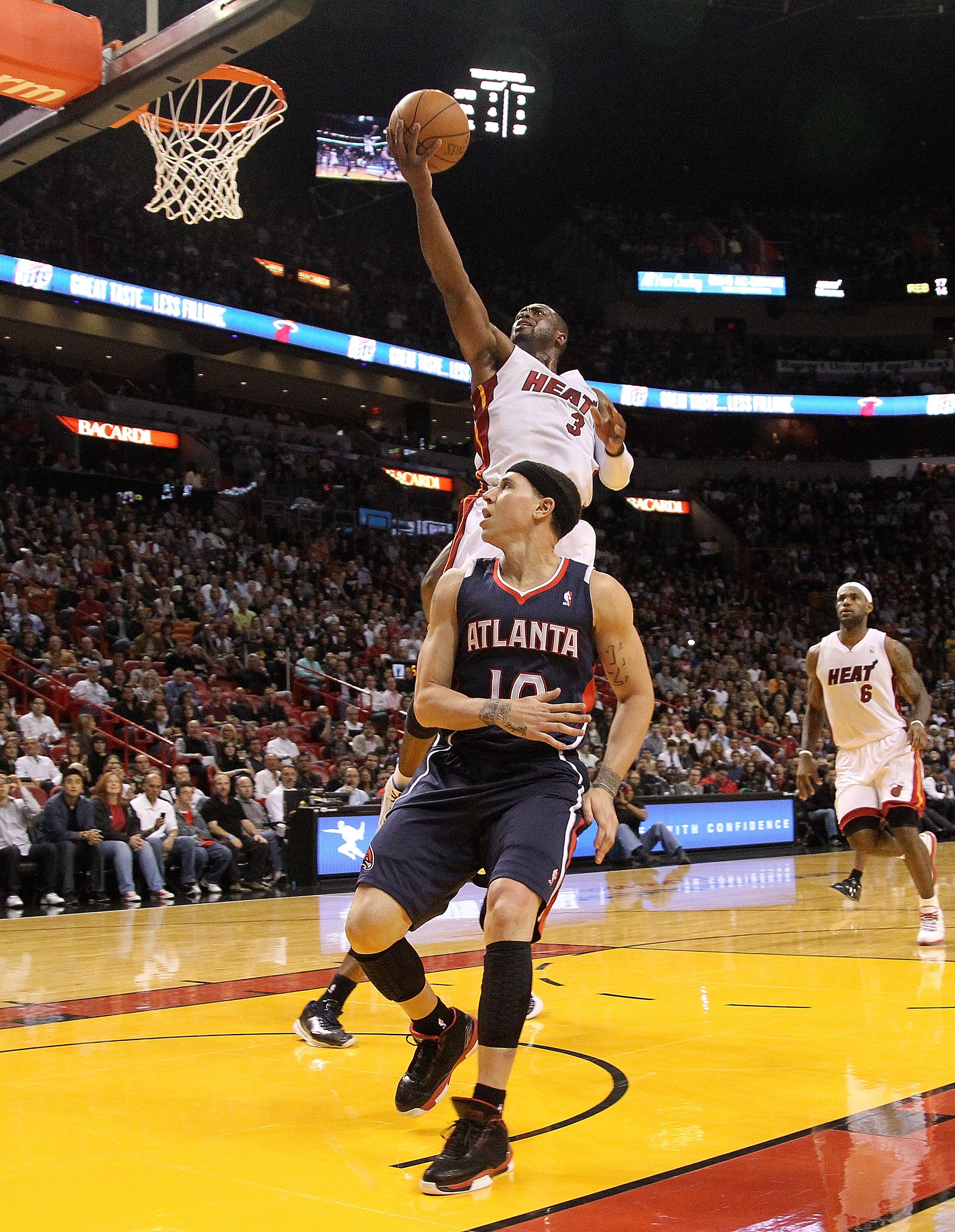 MIAMI, FL - DECEMBER 04: Dwyane Wade #3 of the Miami Heat shoots over Mike Bibby #10 of the Atlanta Hawks during a game at American Airlines Arena on December 4, 2010 in Miami, Florida. NOTE TO USER: User expressly acknowledges and agrees that, by downloa