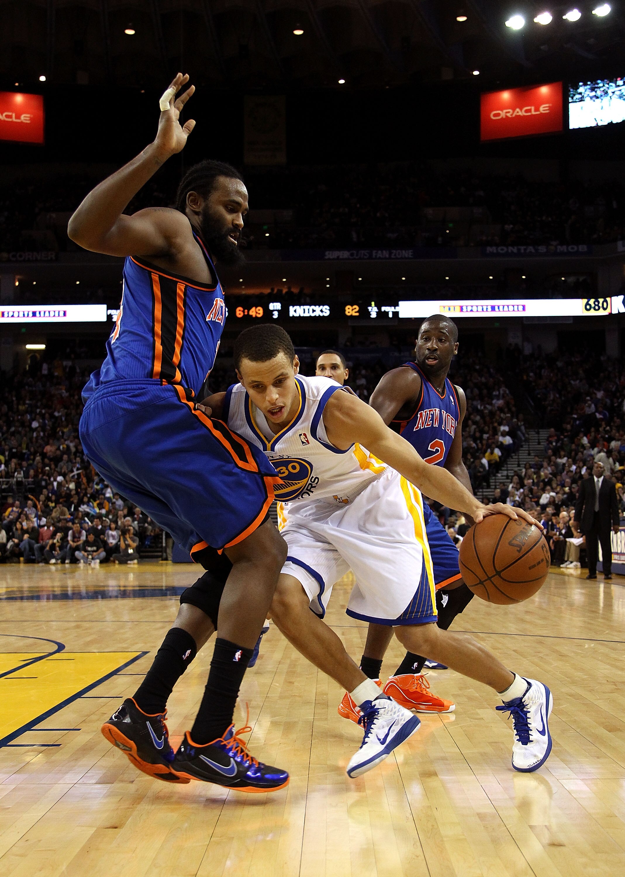 OAKLAND, CA - NOVEMBER 19:  Stephen Curry #30 of the Golden State Warriors drives on Ronny Turiaf #14 of the New York Knicks at Oracle Arena on November 19, 2010 in Oakland, California. NOTE TO USER: User expressly acknowledges and agrees that, by downloa