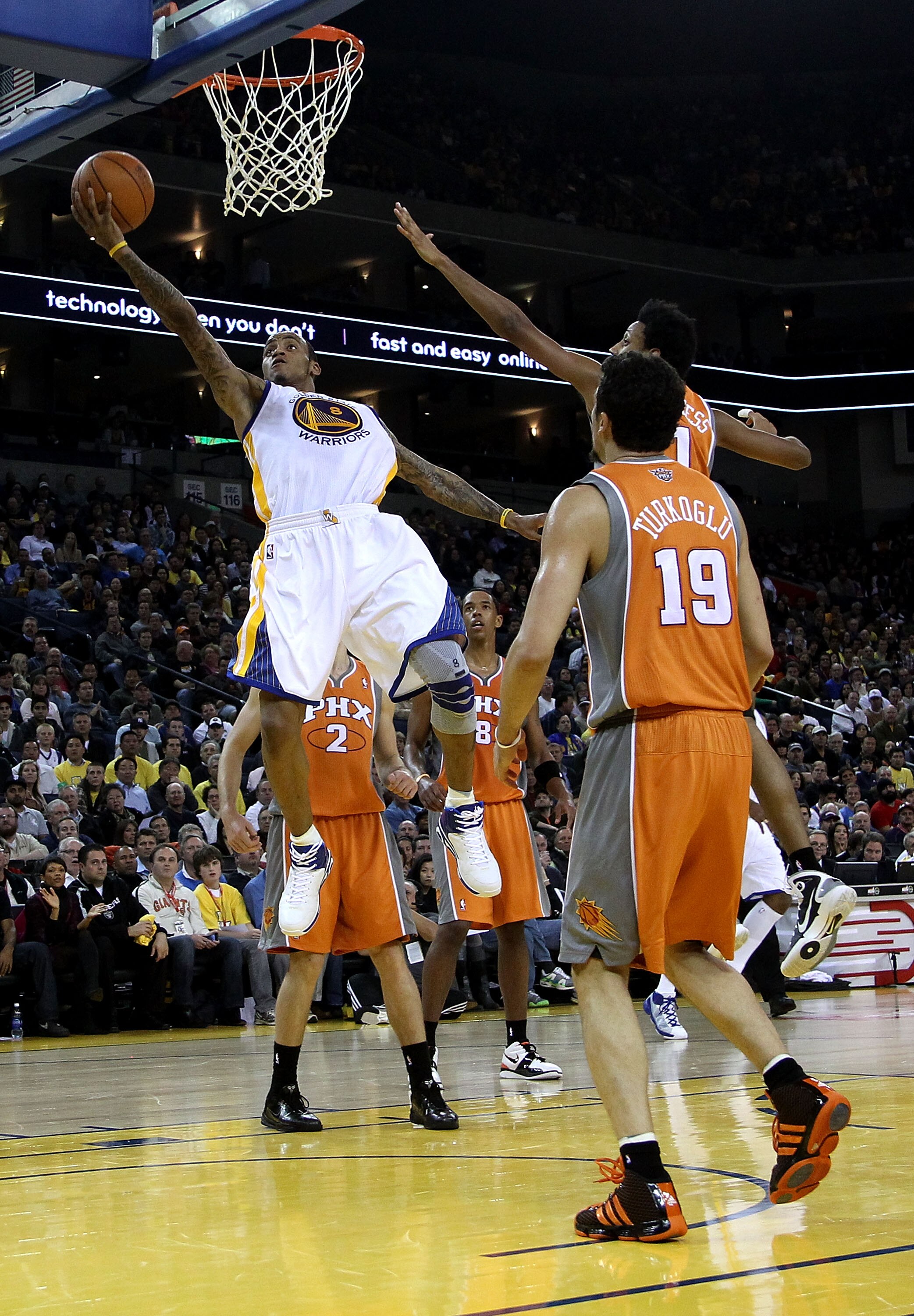 OAKLAND, CA - DECEMBER 02:  Monta Ellis #8 of the Golden State Warriors drives to the basket against the Phoenix Suns at Oracle Arena on December 2, 2010 in Oakland, California. NOTE TO USER: User expressly acknowledges and agrees that, by downloading and