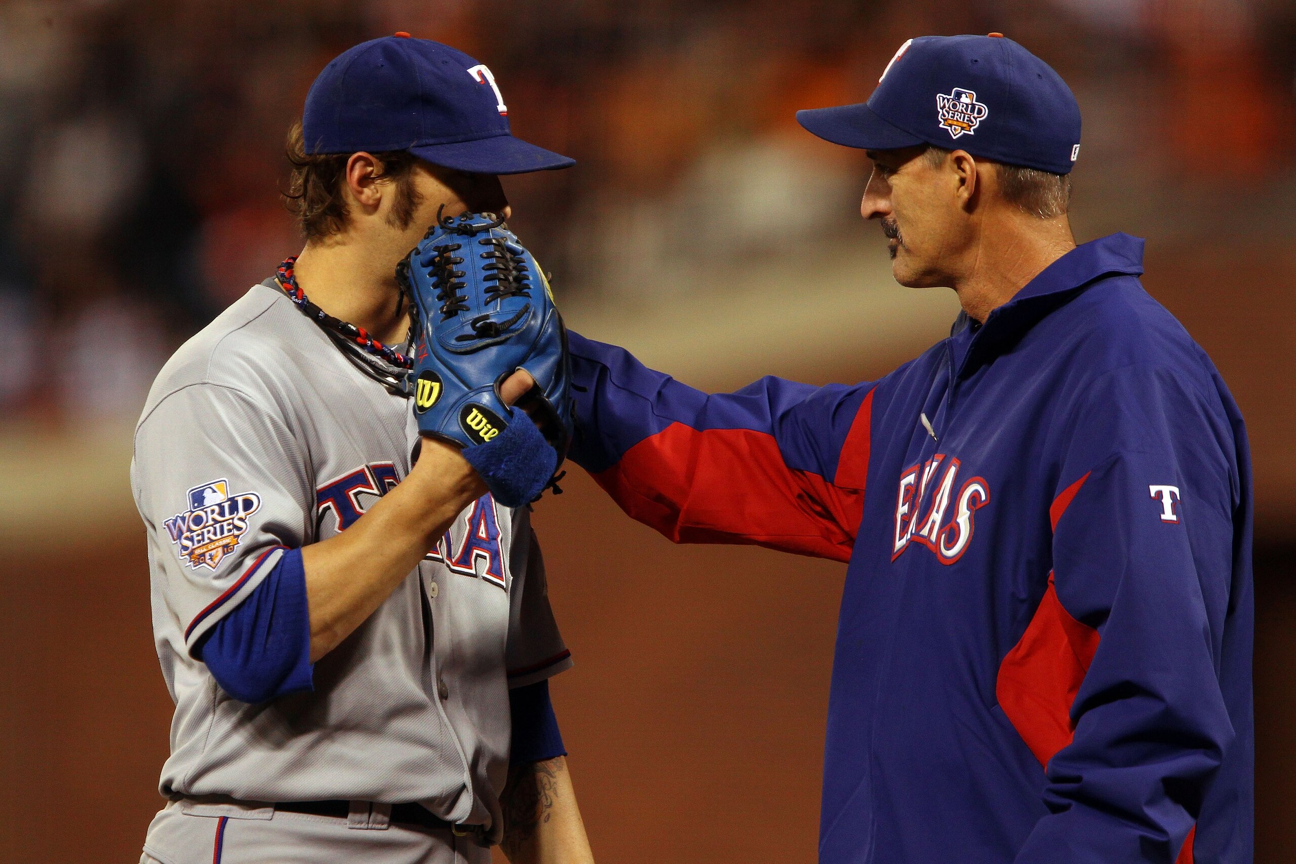 SAN FRANCISCO - OCTOBER 28:  C.J. Wilson #36 of the Texas Rangers has a meeting on the mound with pitching coach Mike Maddux in the seventh inning against the San Francisco Giants in Game Two of the 2010 MLB World Series at AT&T Park on October 28, 2010 i