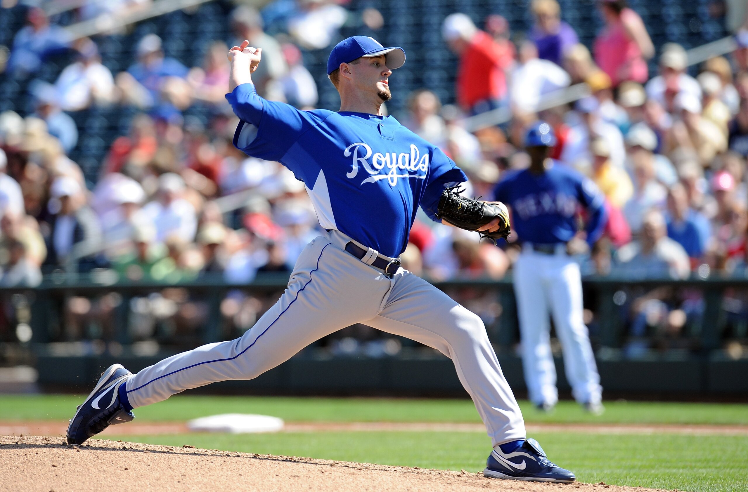 SURPRISE, AZ - MARCH 06:  Gil Meche #55 of the Kansas City Royals pitches during a Spring Training game against the Texas Rangers on March 6, 2010 in Surprise, Arizona.  (Photo by Lisa Blumenfeld/Getty Images)