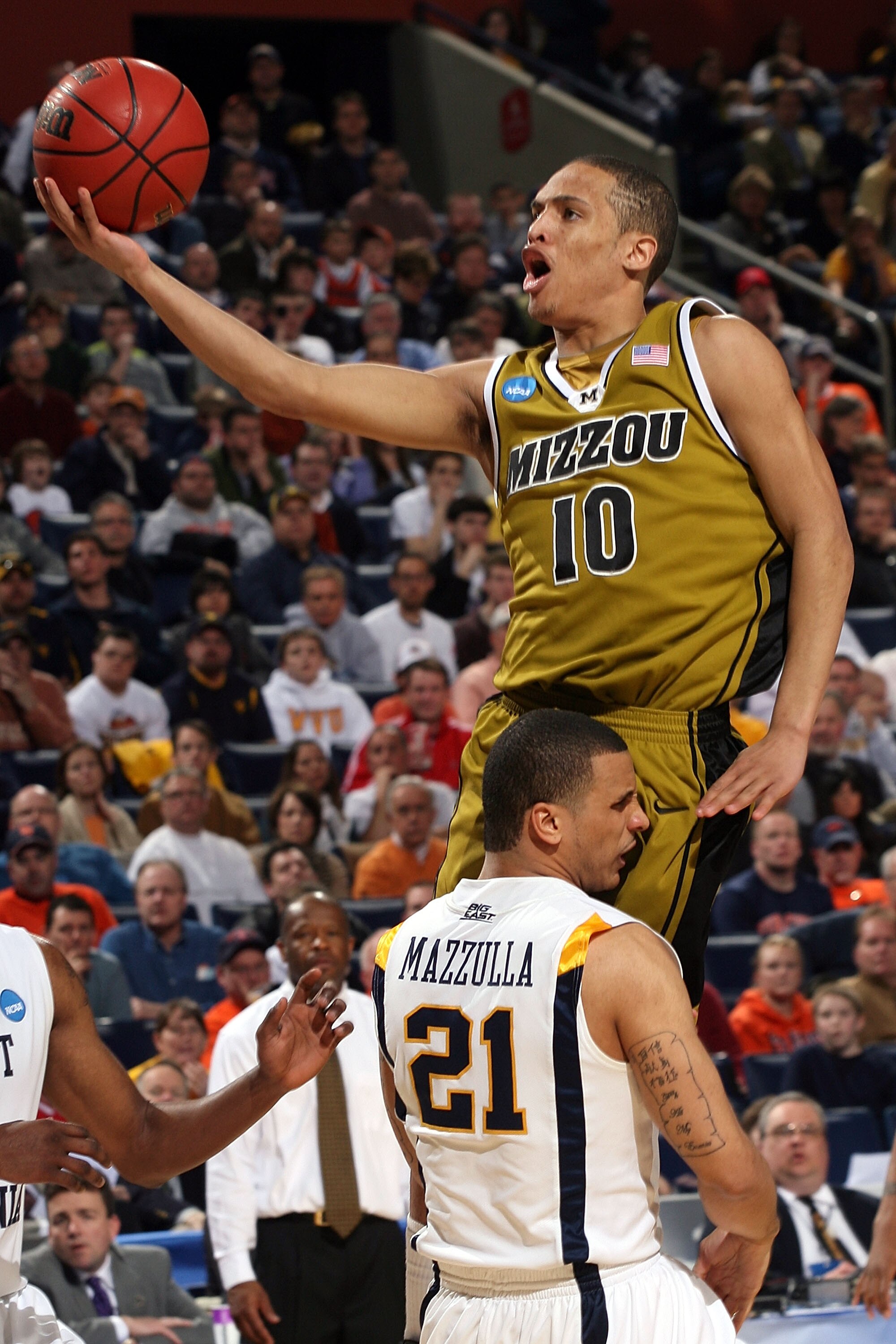 BUFFALO, NY - MARCH 21:  Michael Dixon #10 of the Missouri Tigers draws contact against Joe Mazzulla #21 of the West Virginia Mountaineers during the second round of the 2010 NCAA men's basketball tournament at HSBC Arena at HSBC Arena on March 21, 2010 i