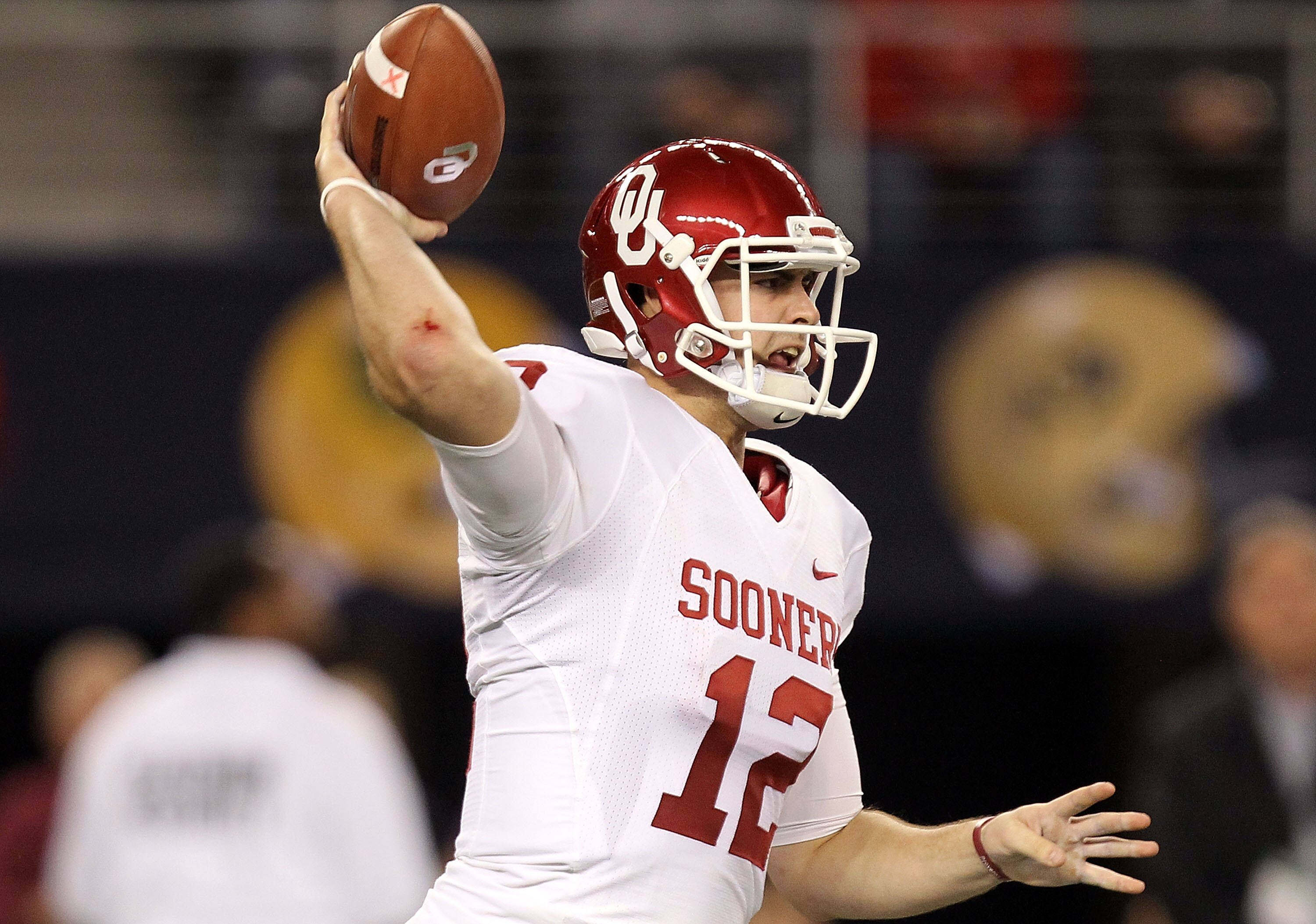 ARLINGTON, TX - DECEMBER 04:  Quarterback Landry Jones #12 of the Oklahoma Sooners drops back to pass against the Nebraska Cornhuskers during the Big 12 Championship at Cowboys Stadium on December 4, 2010 in Arlington, Texas.  (Photo by Ronald Martinez/Ge